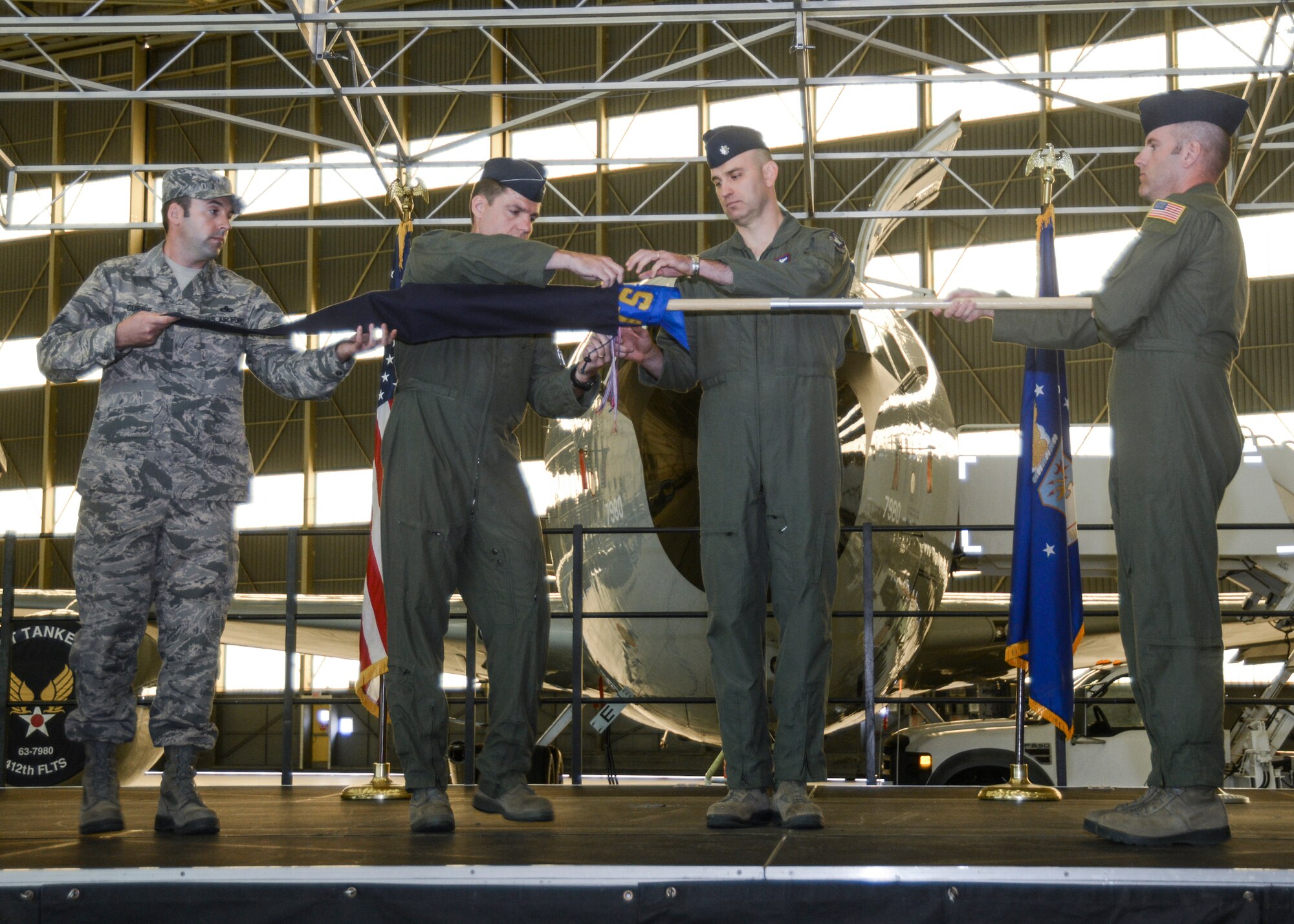 The 412th Flight Test Squadron was inactivated after 21 years of service May 15. A specially modified KC-135 aerial refueler, the “Speckled Trout” will now serve as air refueling support in the 418th Flight Test Squadron. Col. Rod Todaro (center-left), 412th Operations Group commander, and Lt. Col. Michael Davis (center-right), 412th FLTS commander, furl the 412th FLTS guidon signifying the deactivation of the squadron. (U.S. Air Force photo by Rebecca Amber)