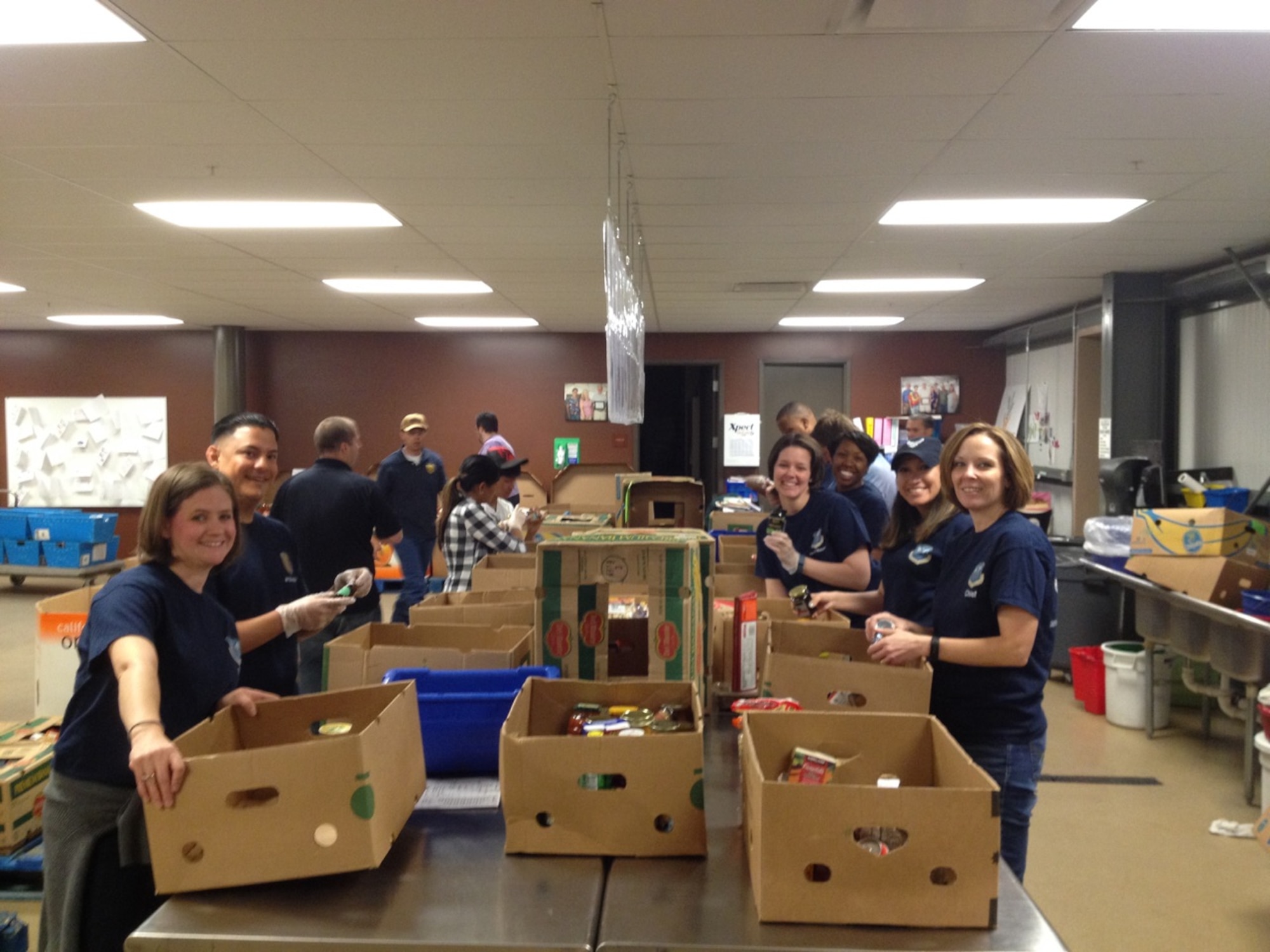 AFOSI’s Region 8 personnel volunteered, May 15, 2015, at a food bank in Colorado Springs, Colo., as part of the U.S. Postal Service Care and Share food drive. Region 8 members sorted food that was recently collected.