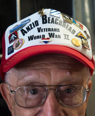 John Boller, shows off his World War II pins, May 15, 2015 at Joint Base Charleston, S.C. during a tour of the installation. Twenty three Anzio veterans were in Charleston to celebrate what could be their last reunion event together and to share their stories with the servicemembers stationed here. Boller who is 90-years-old was a member of the 3rd Infantry Division. The invasion of Anzio, near the outskirts of Rome, began Jan. 22, 1944, lasted four months and took the lives of nearly 2,800 Americans . (U.S. Air Force photo/Senior Airman Jared Trimarchi) 