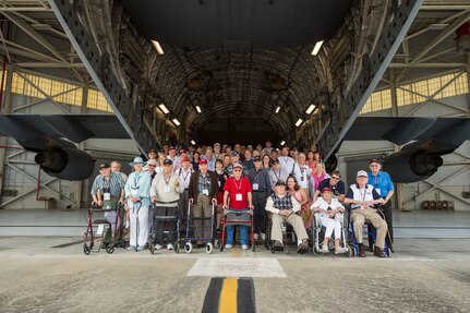 More than 20 veterans from the Anzio Beachhead Invasion of 1944, pose for a group photo with their family members behind a C-17 Globemaster III, at Joint Base Charleston, S.C. during a tour of the installation. The veterans were in Charleston to celebrate what could be their last reunion event together and to share their stories with the servicemembers stationed here. The invasion of Anzio, near the outskirts of Rome, began Jan. 22, 1944, lasted four months and took the lives of nearly 2,800 Americans . (U.S. Air Force photo/Senior Airman Jared Trimarchi) 