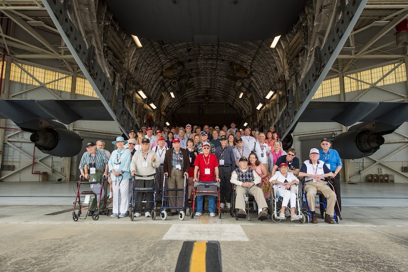More than 20 veterans from the Anzio Beachhead Invasion of 1944, pose for a group photo with their family members behind a C-17 Globemaster III, at Joint Base Charleston, S.C. during a tour of the installation. The veterans were in Charleston to celebrate what could be their last reunion event together and to share their stories with the servicemembers stationed here. The invasion of Anzio, near the outskirts of Rome, began Jan. 22, 1944, lasted four months and took the lives of nearly 2,800 Americans . (U.S. Air Force photo/Senior Airman Jared Trimarchi) 