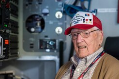 Kenneth Muston, an Anzio Beachhead Invasion veteran poses for a photo in the loadmaster seat on a C-17 Globemaster III, May 15, 2015 at Joint Base Charleston, S.C. during a tour of the installation. More than 20 veterans from the event were in Charleston to celebrate what could be their last reunion event together and to share their stories with the servicemembers stationed here. Muston, who is 91-years-old was a private first class from B Company 3rd Infantry Division. The invasion of Anzio, near the outskirts of Rome, began Jan. 22, 1944, lasted four months and took the lives of nearly 2,800 Americans. (U.S. Air Force photo/Senior Airman Jared Trimarchi) 