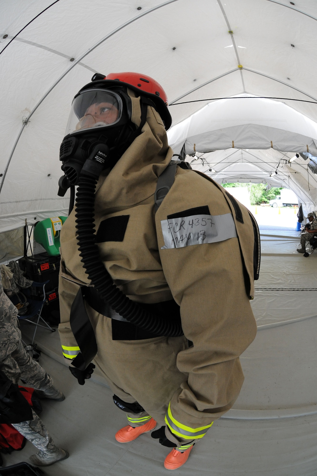 Tech. Sgt. Chito Reyes, 113th services flight, D.C. Air National Guard, suits up during Chemical Biological Radiological Nuclear (CBRN) Emergency Response Force Package training, May 14, 2015 in Virginia Beach, Va. Reyes is part of the 113th wing Fatality Search and Recovery Team.  (U.S. Air National Guard photo by Airman 1st Class Anthony Small)