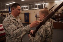 Airman 1st Class Eric Merriman, 5th Logistic Readiness Squadron vehicle maintainer, helps an Honor Guard trainee at Minot Air Force Base, N.D., May 14, 2015. Airmen that go through Honor Guard training become a representation of the Air Force at ceremonies and events. (U.S. Air Force photo/Airman 1st Class Christian Sullivan)