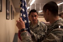 Senior Airman Joshua Rolli, 5th Civil Engineering Squadron heavy equipment operator, helps an Airman in the Honor Guard training program. Rolli said Honor Guard has given him more responsibility as a trainer since joining. (U.S. Air Force photo/Airman 1st Class Christian Sullivan)