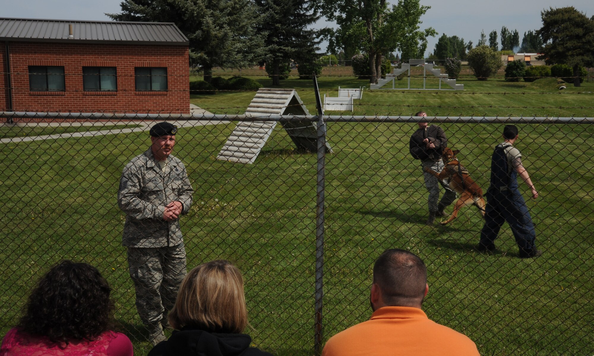 Master Sgt. Brandon Tillman, 92nd Security Forces Squadron military working dog kennel master, shows Uutah, a Belgian malinois K9 Airman, biting a handler during a simulation of suspect apprehension to members of Leadership Spokane at Fairchild Air Force Base, Wash., May 15, 2015. The tour group came to the base to see the operations of one of their community’s largest employers. (U.S. Air Force photo/Senior Airman Sam Fogleman)