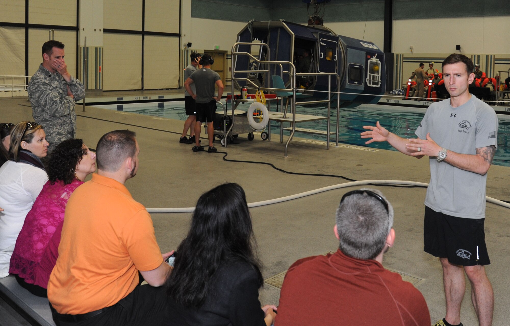Staff Sgt. Joshua Embry, 66th Training Squadron water flight operations NCO, discusses water rescue and combat training simulations with touring members of Leadership Spokane at Fairchild Air Force Base, Wash., May 15, 2015. The members of the non-profit organization were touring the base to gain further understanding of the Spokane area that they represent. (U.S. Air Force photo/Senior Airman Sam Fogleman)