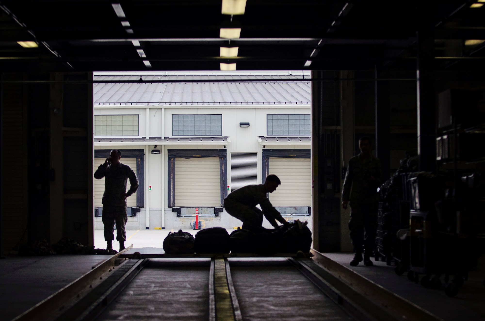Airman 1st Class Nicholas Ladwig, 436th Aerial Port Squadron, inspects a baggage pallet for discrepancies as part of a deployment exercise May 17, 2015 on Dover Air Force Base, Del. More than 60 reservists simulated a large, mass deployment situation, which included deployment briefings and  a "bag drag" of all their combat equipment. (U.S. Air Force photo/Capt. Bernie Kale)