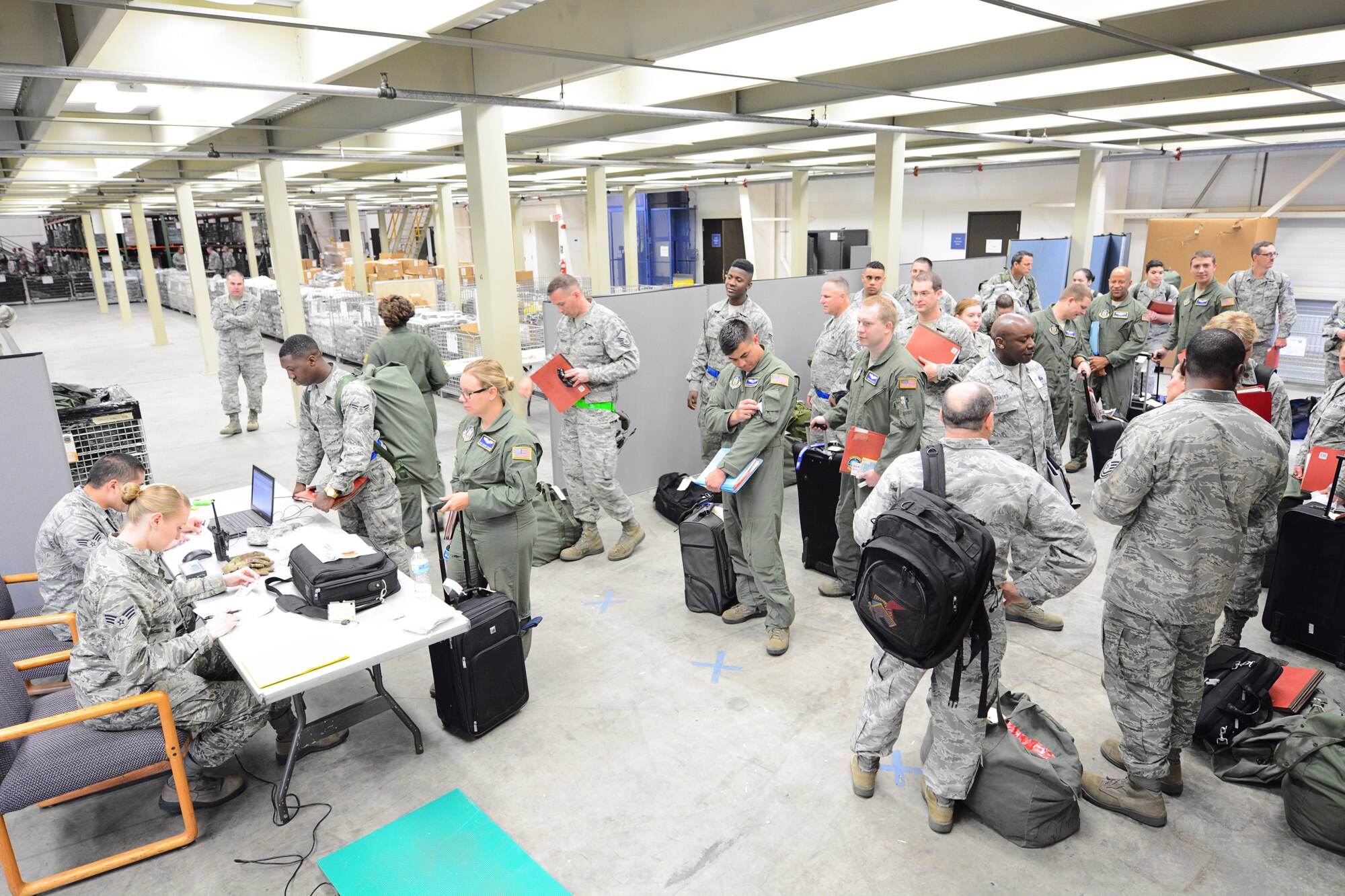 Reservists from the 512th Airlift Wing sign into the Mobility Processing Center prior to receiving issued combat equipment as part of a deployment exercise May 17, 2015, at Dover Air Force Base, Del. The DEPEX was a joint collaboration between the 512th and 436th airlift wings. (U.S. Air Force Photo/Staff Sgt. Mercedes Crossland)