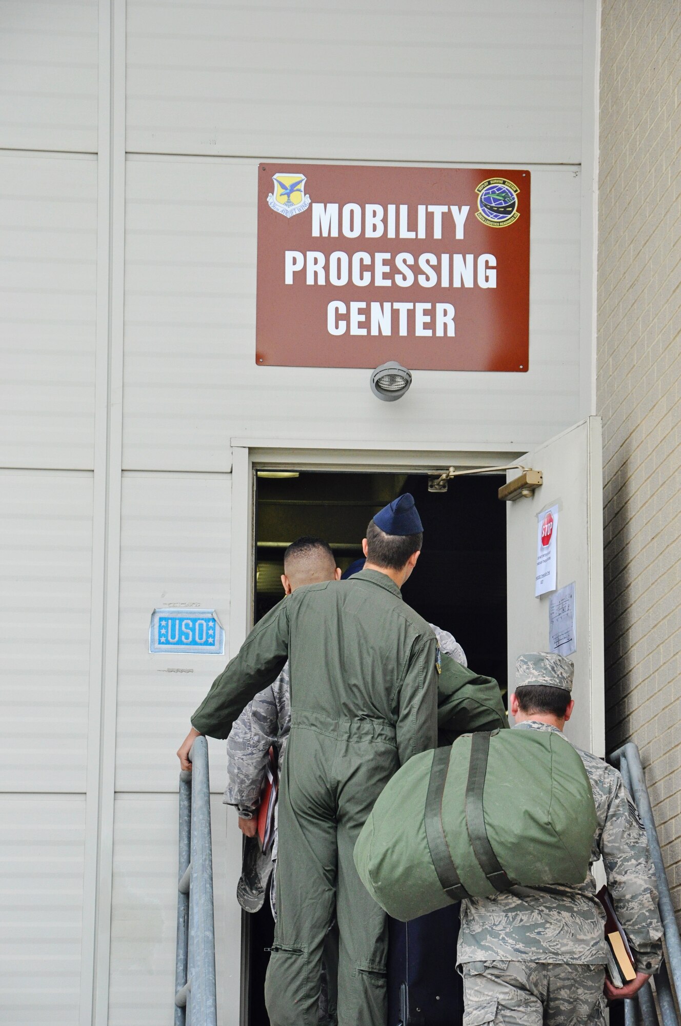 Airmen from the 512th Airlift Wing wait to enter the Mobility Processing Center May 17, 2015, as part of a deployment exercise on Dover Air Force Base, Del. About 60 reservists had their personnel folders reviewed and personal bags palletized as part of the deployment process. (U.S. Air Force photo/Master Sgt. Veronica Aceveda)