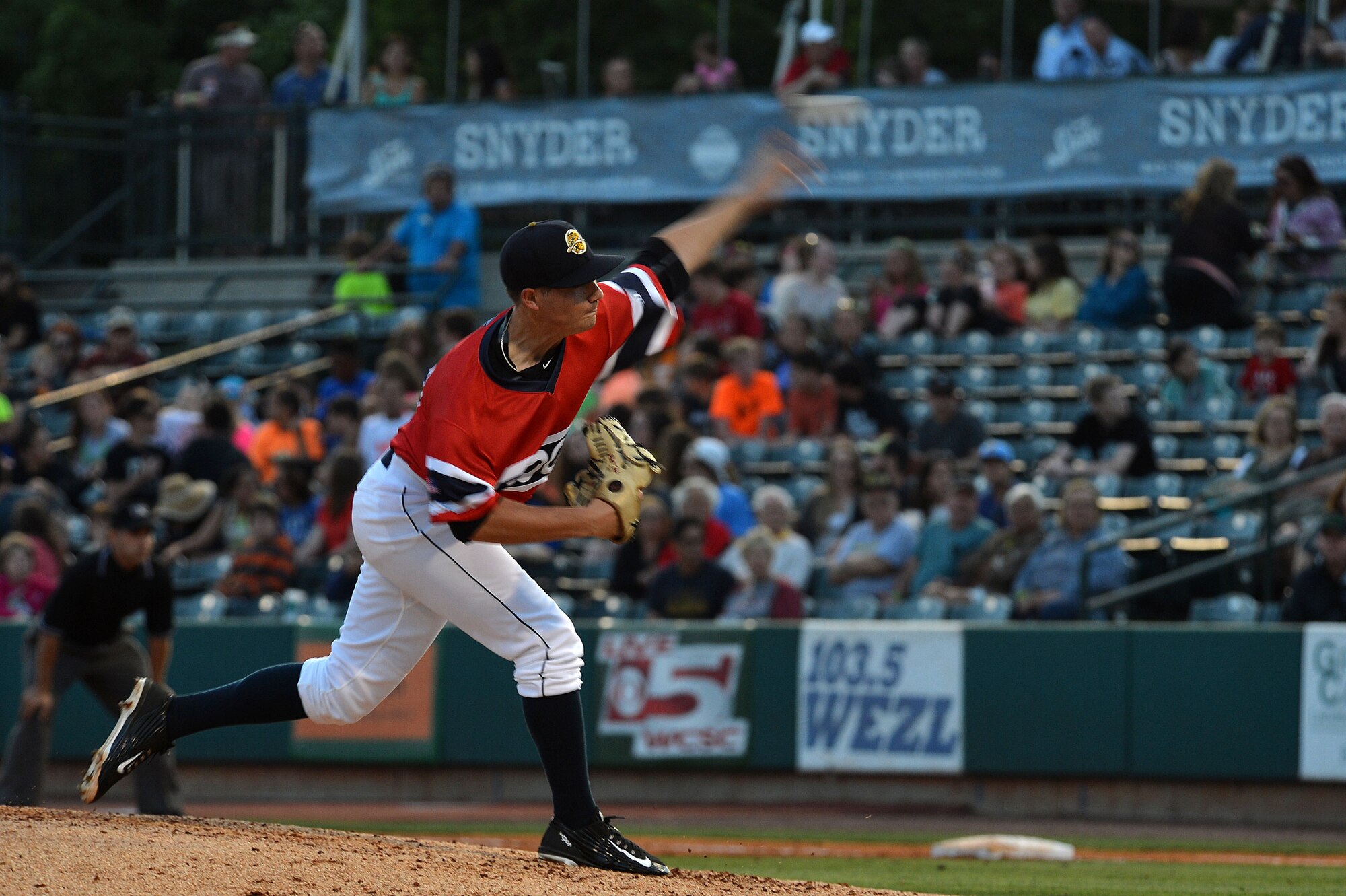 A Charleston RiverDogs baseball player pitches a ball during a military appreciation day baseball game between the Charleston RiverDogs and the Greenville Drive at Joseph P. Riley Jr. Ballpark, Charleston, S.C., May 14, 2015. Approximately 7,000 military members and baseball fans watched the game and enjoyed activities. (U.S. Air Force photo by Airman 1st Class Michael Cossaboom/Released)
