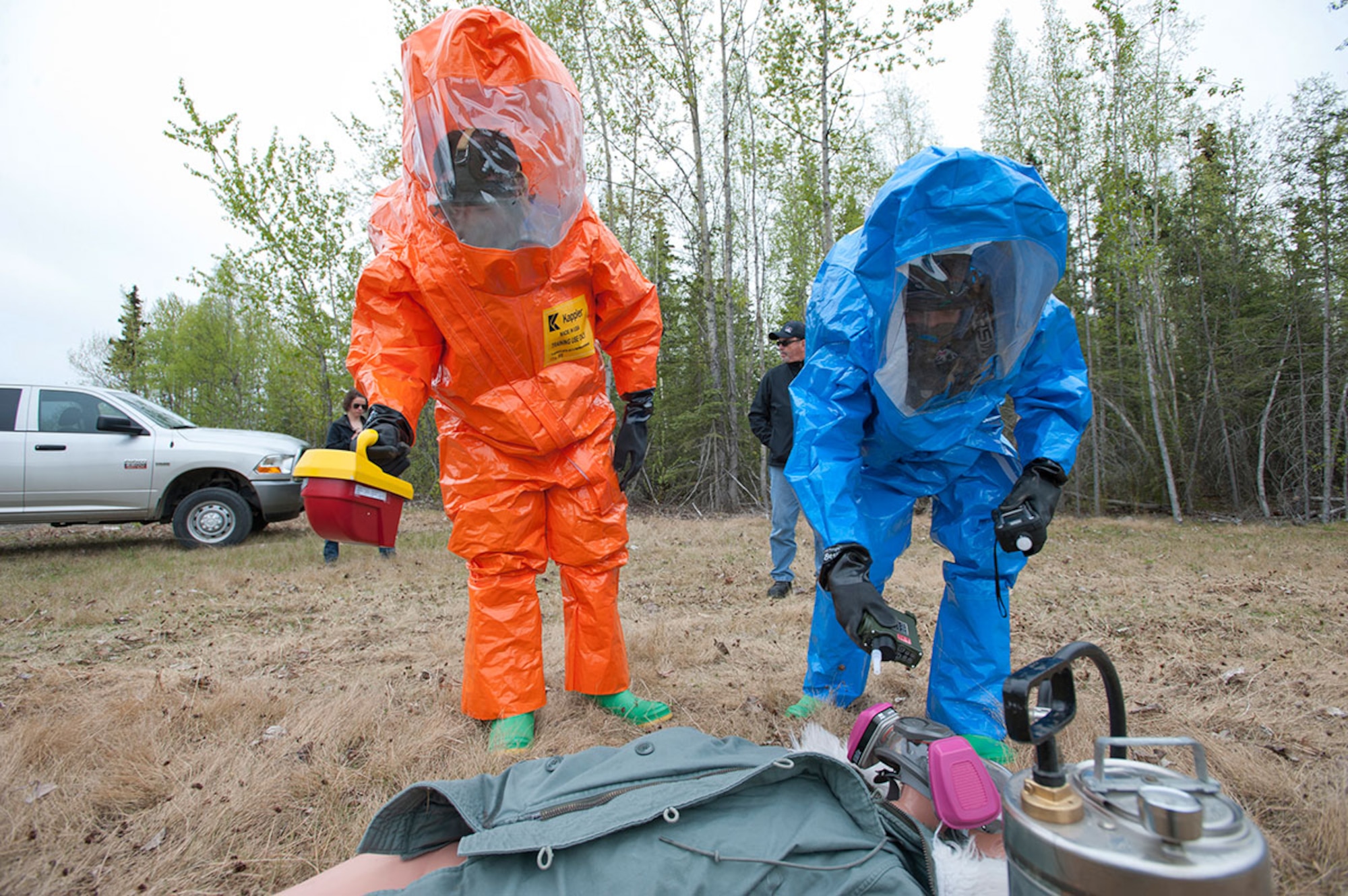 Air National Guard Staff Sgt. James Mainolfi, left, and Senior Airman Matthew Castellanos prepare to take hazard readings from a simulated body during Integrated Base Emergency Response Training on Joint Base Elmendorf-Richardson, Alaska, May 14, 2015. The annual training is mandated by Pacific Air Forces to give the units more in-depth training into their fields than exercises normally give. Mainolfi is a 176th Medical Group bio-environmental engineering technician. Castellanos is a 773d Civil Engineer Squadron emergency medicine technician. (U.S. Air Force photo/Tech. Sgt. Robert Barnett)