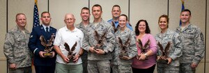 Col. Jeffrey DeVore, Joint Base Charleston commander, and Chief Master Sgt. Mark Bronson, 628th Air Base Wing command chief, pose for a group photo with the award winners during the 628th ABW Quarterly Awards Ceremony May 13, 2015, at the Charleston Club on JB Charleston, S.C. The winners are (left to right) Senior Airman Michael Cassar, Honor Guard Member of the Quarter, Mr. Donald Reed, Volunteer of the Quarter, Capt. James Ferrel, CGO of the Quarter, Tech. Sgt. Kenneth Angel, Noncommissioned Officer of the Quarter, Mr. Jason Frederickson, Cat I Civilian of the Quarter, Airman 1st Class Mariah Magtoto, Airman of the Quarter, Ms. Sandra Walker-Halliman, Cat II Civilian of the Quarter and Master Sgt. Caroline Bunce, SNCO of the Quarter. The Quarterly Awards are held to recognize outstanding Airmen, noncommisioned officers, senior noncomissioned officers, company grade officers and civilians for their hard work and dedication. (U.S. Air Force photo/Airman 1st Class Clayton Cupit)