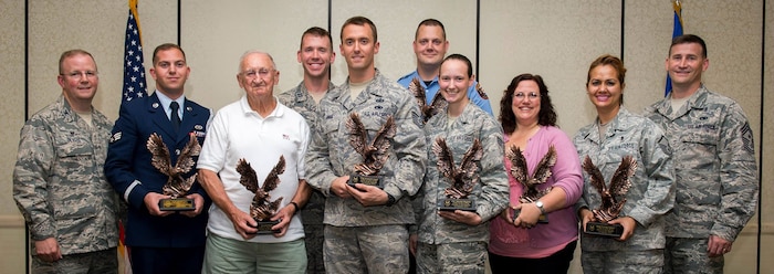 Col. Jeffrey DeVore, Joint Base Charleston commander, and Chief Master Sgt. Mark Bronson, 628th Air Base Wing command chief, pose for a group photo with the award winners during the 628th ABW Quarterly Awards Ceremony May 13, 2015, at the Charleston Club on JB Charleston, S.C. The winners are (left to right) Senior Airman Michael Cassar, Honor Guard Member of the Quarter, Mr. Donald Reed, Volunteer of the Quarter, Capt. James Ferrel, CGO of the Quarter, Tech. Sgt. Kenneth Angel, Noncommissioned Officer of the Quarter, Mr. Jason Frederickson, Cat I Civilian of the Quarter, Airman 1st Class Mariah Magtoto, Airman of the Quarter, Ms. Sandra Walker-Halliman, Cat II Civilian of the Quarter and Master Sgt. Caroline Bunce, SNCO of the Quarter. The Quarterly Awards are held to recognize outstanding Airmen, noncommisioned officers, senior noncomissioned officers, company grade officers and civilians for their hard work and dedication. (U.S. Air Force photo/Airman 1st Class Clayton Cupit)