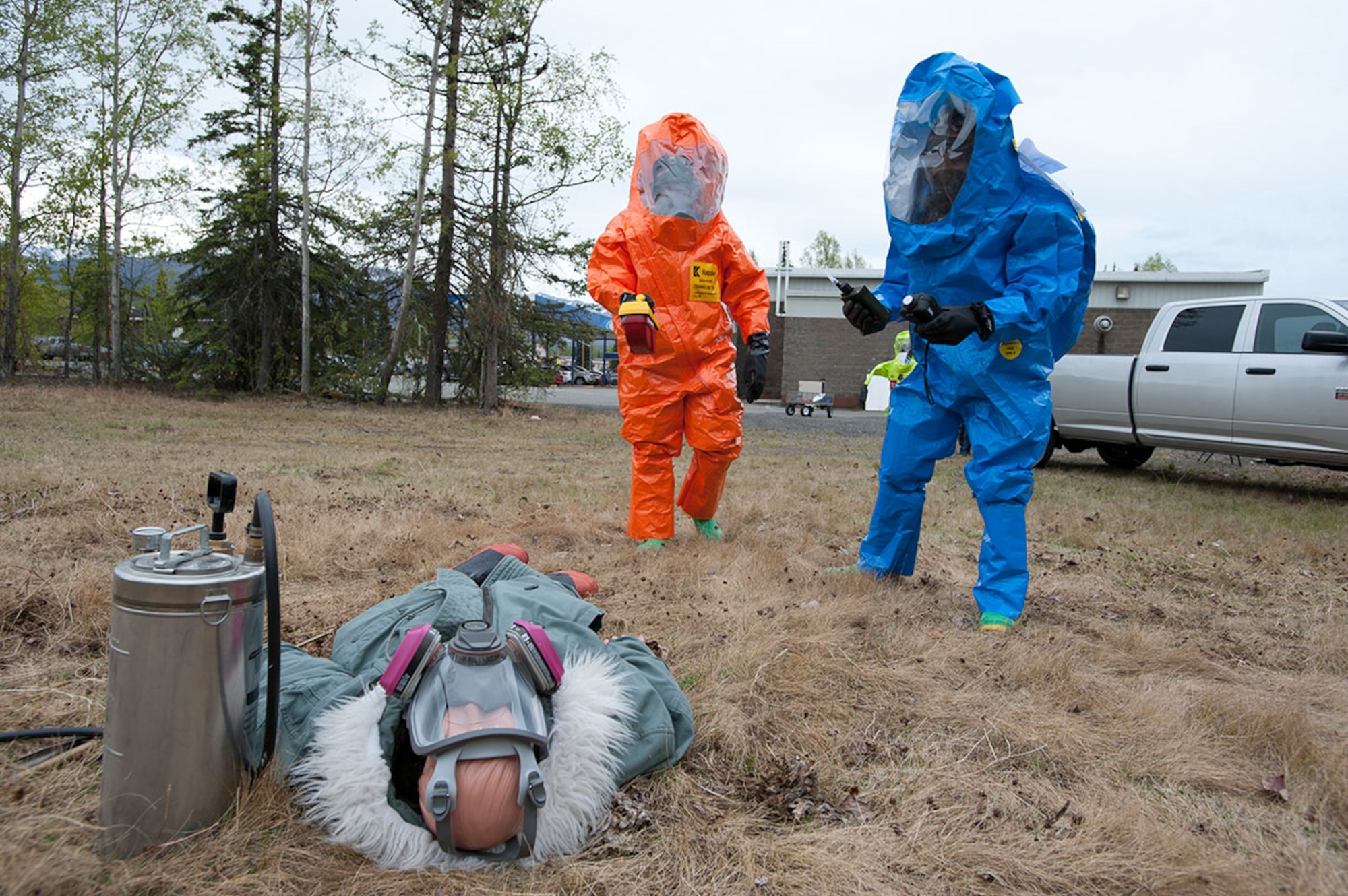 Air National Guard Staff Sgt. James Mainolfi, left, and Senior Airman Matthew Castellanos prepare to take hazard readings from a simulated body during Integrated Base Emergency Response Training on Joint Base Elmendorf-Richardson, Alaska, May 14, 2015. The annual training is mandated by Pacific Air Forces to give the units more in-depth training into their fields than exercises normally give. Mainolfi is a 176th Medical Group bio-environmental engineering technician. Castellanos is a 773d Civil Engineer Squadron emergency medicine technician. (U.S. Air Force photo/Tech. Sgt. Robert Barnett)