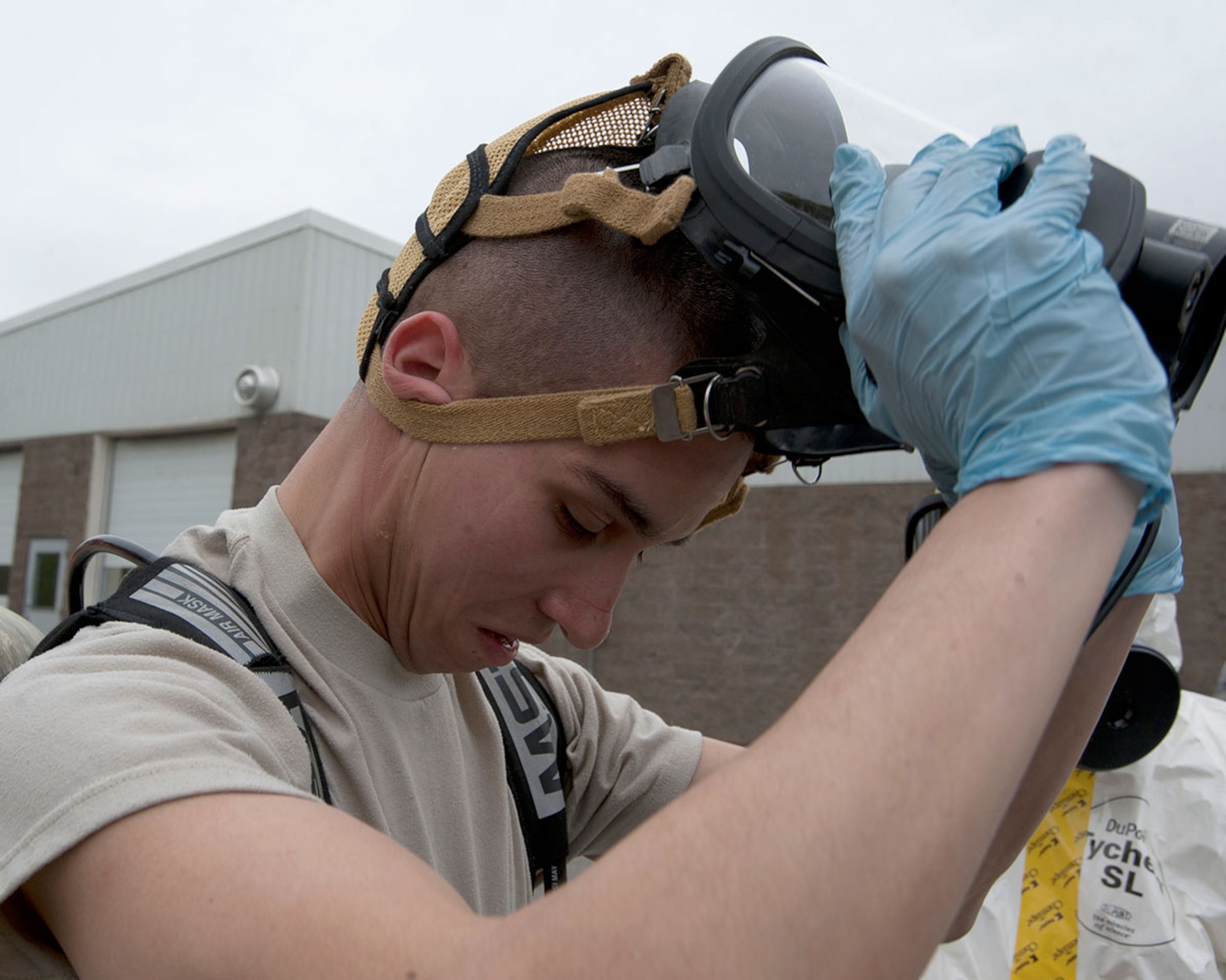 Senior Airman Matthew Castellanos gets his first breath of fresh air after simulated decontamination during Integrated Base Emergency Response Training on Joint Base Elmendorf-Richardson, Alaska, May 14, 2015. Castellanos is a 773d Civil Engineer Squadron bio-environmental engineering technician and a native of Wescovena, Calif. (U.S. Air Force photo/Tech. Sgt. Robert Barnett)