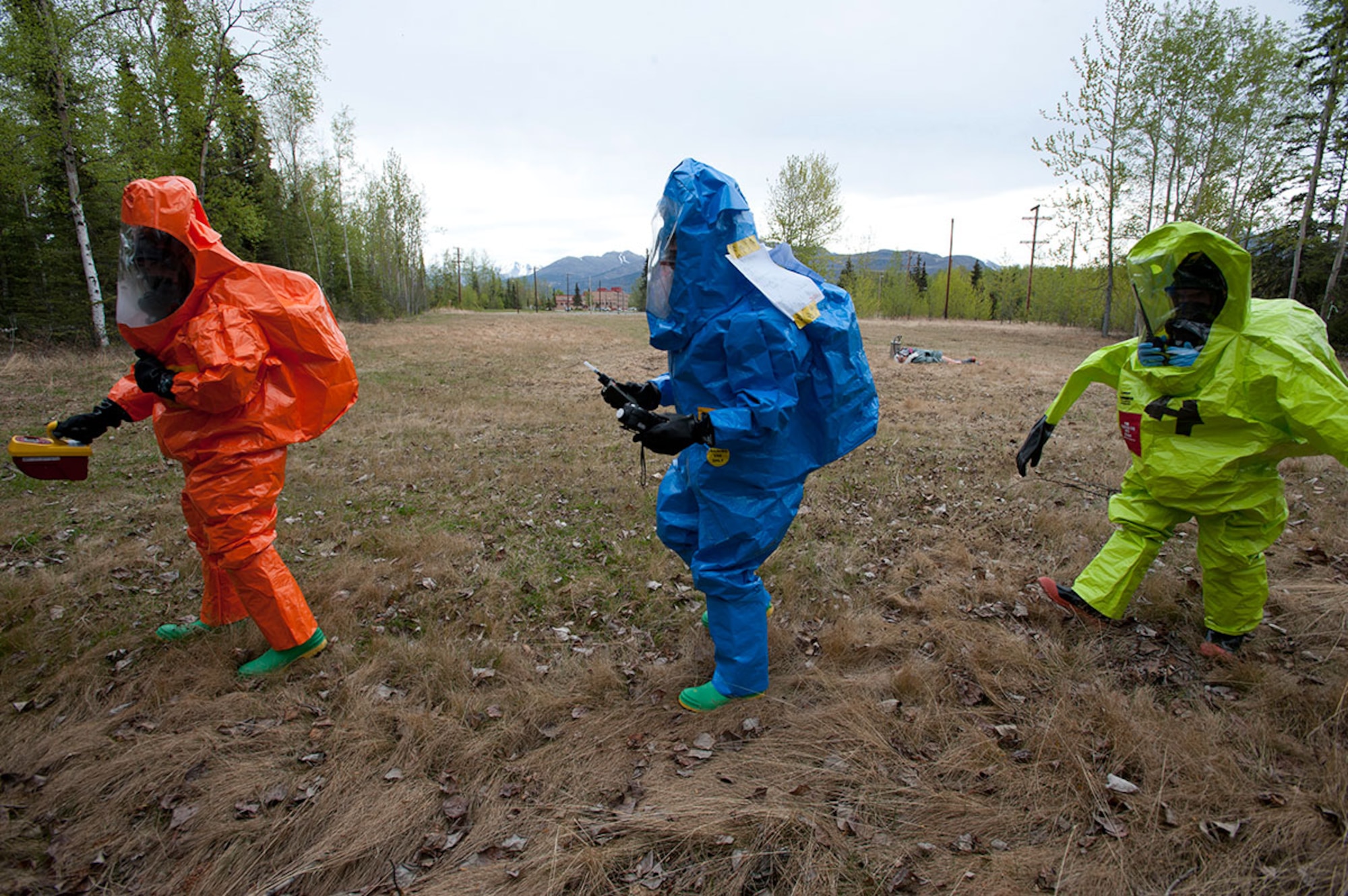 Air National Guard Staff Sgt. James Mainolfi, left, Senior Airman Matthew Castellanos, center, and Senior Airman Alex Liccione check the immediate area of a training scenario for hazardous chemicals on Joint Base Elmendorf-Richardson, Alaska, May 14, 2015. Mainolfi is a 176th Medical Group bio-environmental engineering technician and a native of Rutland, Vermont. Castellanos is a 773d Civil Engineer Squadron bio-environmental engineering technician and a native of Wescovena, Calif. Liccione is a 673d Aerospace Medicine Squadron bio-environmental engineering technician and a native of New York, New York. (U.S. Air Force photo/Tech. Sgt. Robert Barnett)