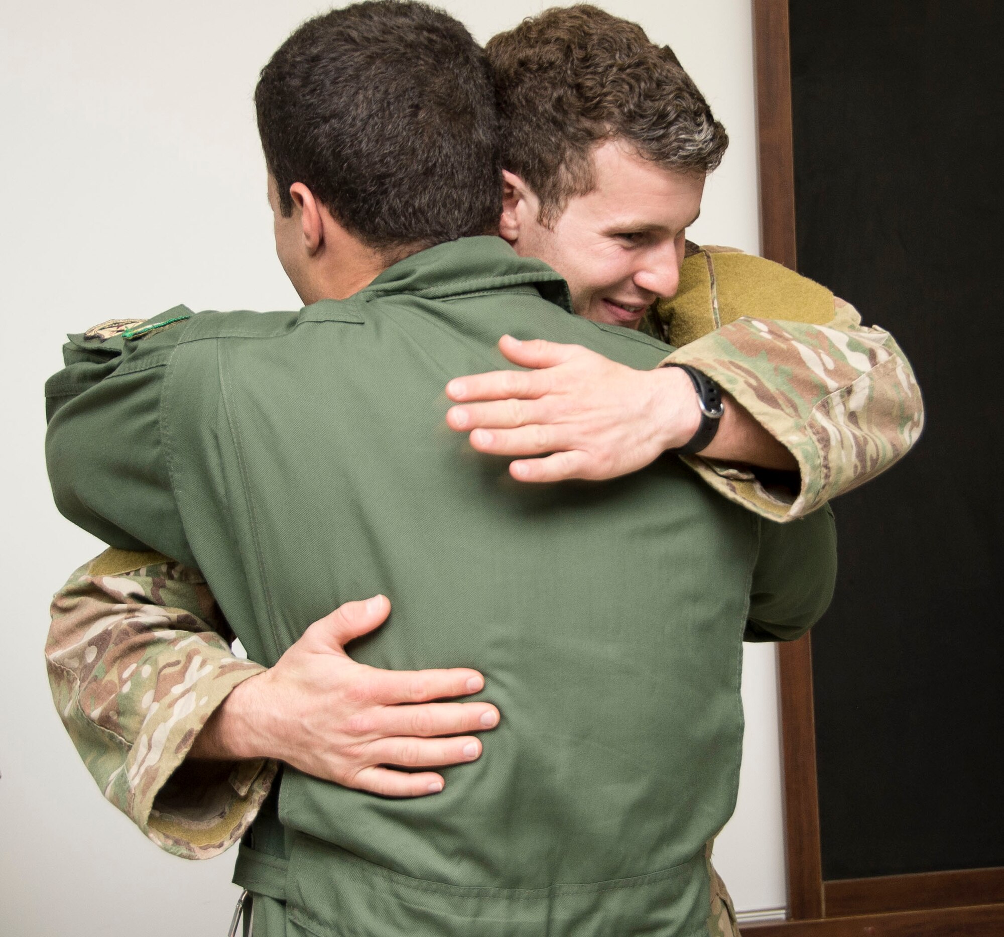 1st Lt. Evan Terry, 38th Rescue Squadron combat rescue officer, hugs a member of the Brazilian air force during the closing moments of a week-long exchange focused on enhancing Search and Rescue capabilities, May 15, 2015 in Campo Grande, Brazil. During the week long exchange Terry shared details of his role and responsibilities as a Combat Search and Rescue Officer. (U.S. Air Force photo by Staff Sgt. Adam Grant/Released)