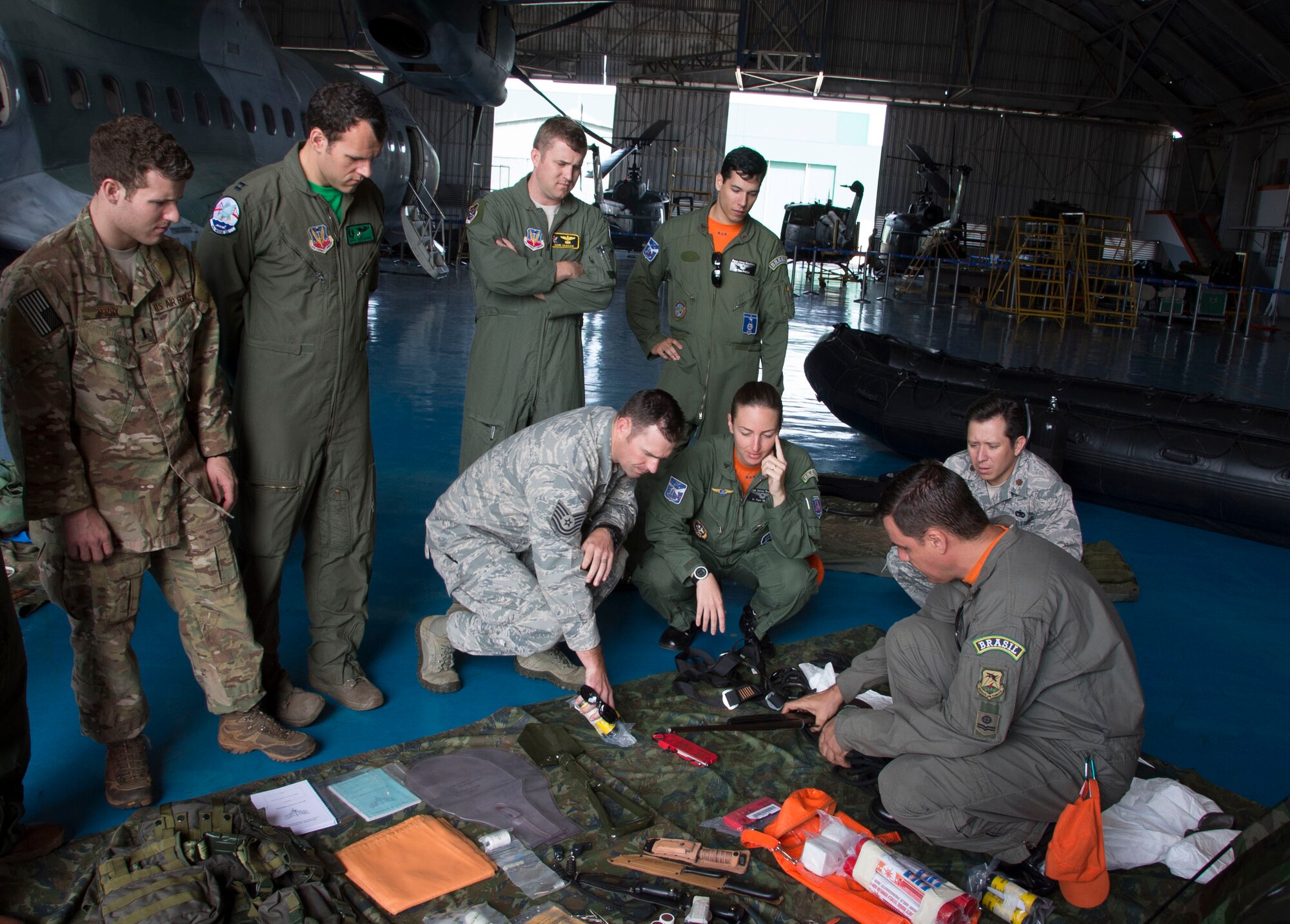 Members of the Brazilian air force present emergency safety equipment from an aircraft to members from Air Forces Southern, May 15, 2015 in Campo Grande, Brazil. The equipment being showcased is pivotal to the survival of the air crew in a worst case scenario where the aircraft crashes. (U.S. Air Force photo by Staff Sgt. Adam Grant/Released)