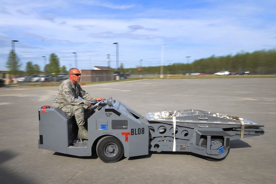 U.S. Air Force Staff Sgt. Joe Behnfeldt, a 180th Maintenance Squadron aerospace ground equipment craftsman, transfers a weapons loader after being processed from the 354th Logistics Readiness Squadron air terminal operations section May 14, 2015, Eielson Air Force Base, Alaska. After being weighed and measured, each piece of cargo goes through a pre-joint inspection before loading onto an aircraft. (U.S. Air Force photo by Senior Airman Ashley Nicole Taylor/Released)  