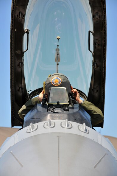 A U.S. Air Force F-16 pilot with the 119th Fighter Squadron, assigned to 177th Fighter Wing of the New Jersey Air National Guard, dons his flight helmet prior to flying a training mission at Tyndall Air Force Base, Fla., May 6, 2015. Fighter pilots, maintainers and support personnel from the 177th FW deployed to Tyndall for Combat Archer training at the 53rd Weapons Evaluations Group, testing weapons systems, from start to finish, in the air-to-air realm. (U.S. Air National Guard photo by Master Sgt. Andrew J. Moseley/Released)