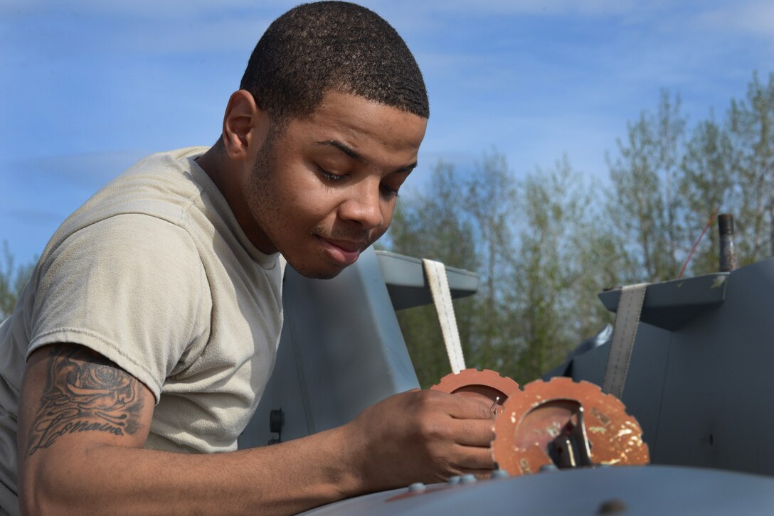 U.S. Air Force Airman 1st Class Joshua Bransom, a 354th Logistics Readiness Squadron traffic management journeyman, checks the levels of a fuel tank May 14, 2015, during RED FLAG-Alaska (RF-A) 15-2 at Eielson Air Force Base, Alaska. Fuel levels along with a basic pre-joint inspection are assessed on each piece of cargo before loading onto an aircraft. (U.S. Air Force photo by Senior Airman Ashley Nicole Taylor/Released)