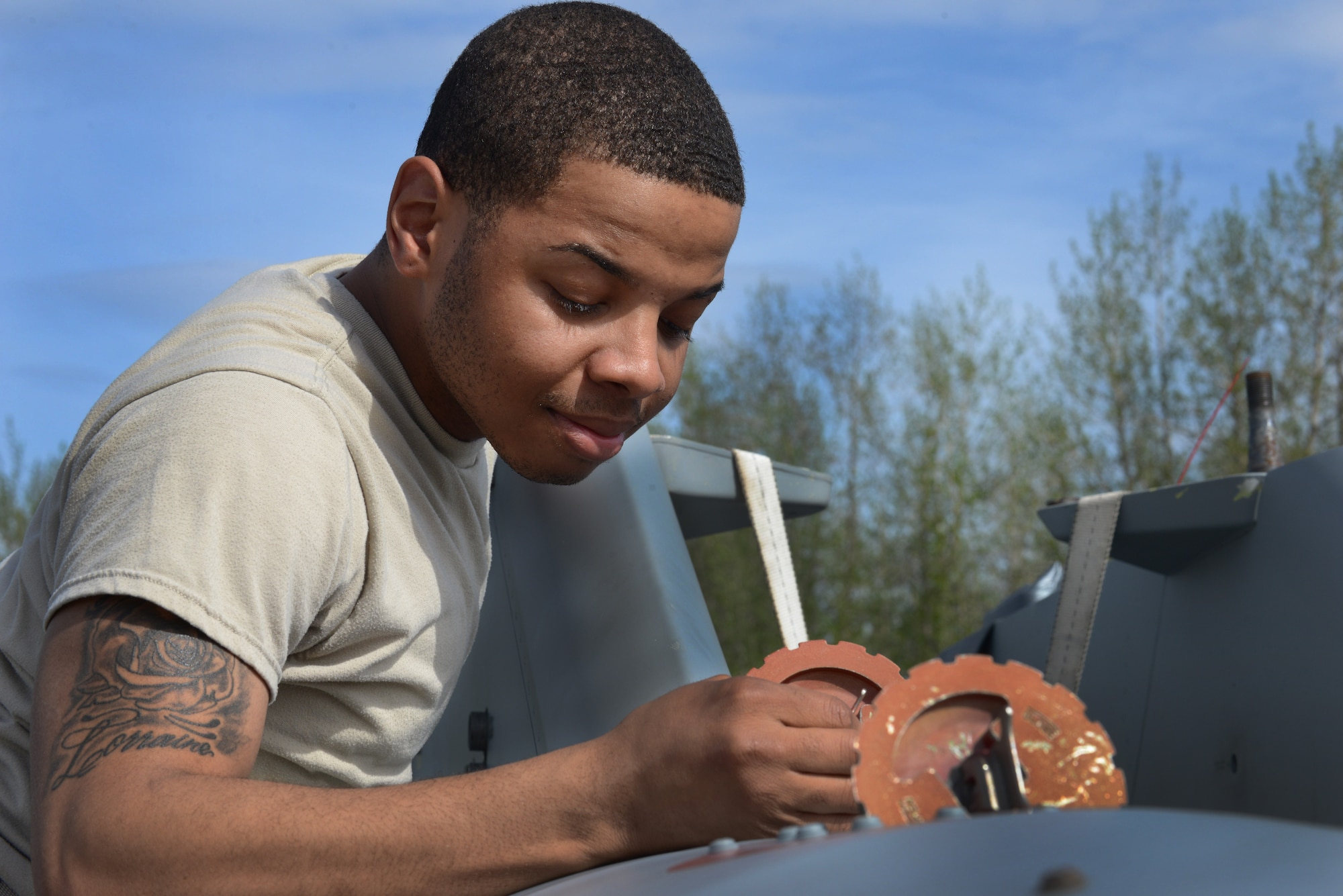 U.S. Air Force Airman 1st Class Joshua Bransom, a 354th Logistics Readiness Squadron traffic management journeyman, checks the levels of a fuel tank May 14, 2015, during RED FLAG-Alaska (RF-A) 15-2 at Eielson Air Force Base, Alaska. Fuel levels along with a basic pre-joint inspection are assessed on each piece of cargo before loading onto an aircraft. (U.S. Air Force photo by Senior Airman Ashley Nicole Taylor/Released)