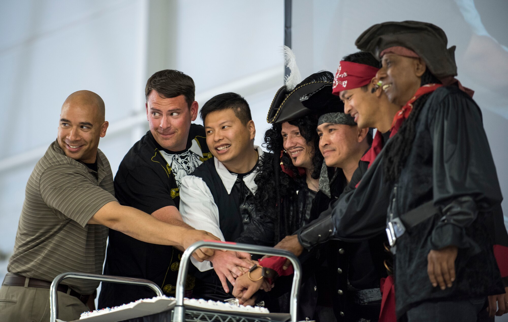 Mountain Home Air Force Base airmen, comprised of U.S. and Singaporean Airmen, pose for a photo during the cake cutting ceremony May 15, 2015 at MHAFB, Idaho. The cake cutting portion is an annual event that signifies the joint-nation partnership.(U.S. Air Force photo by Airman 1st Class Jeremy L. Mosier/Released)