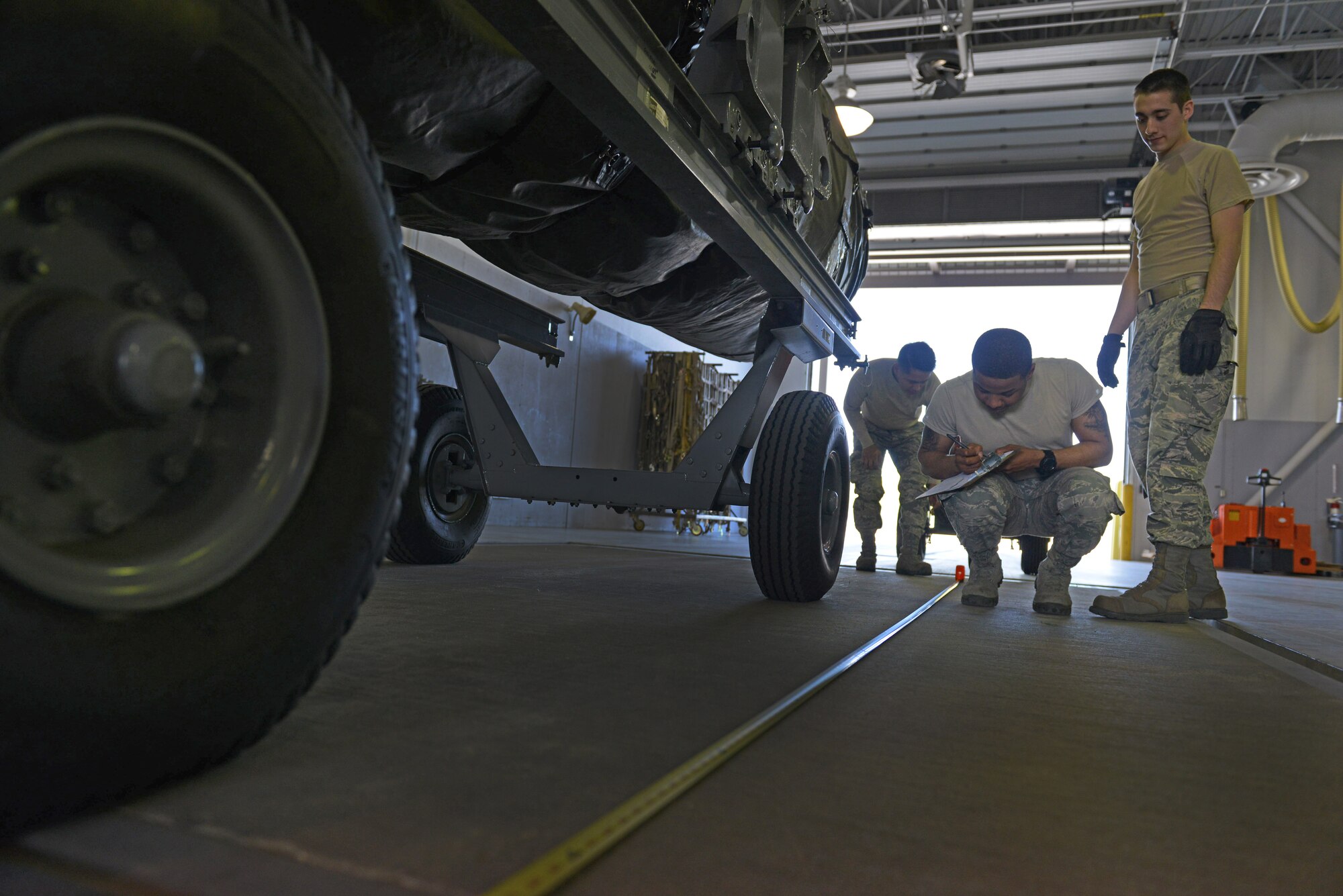 U.S. Air Force Airmen assigned to the 354th Logistics Readiness Squadron measure a cargo load May 14, 2015, during RED FLAG-Alaska (RF-A) 15-2 at Eielson Air Force Base, Alaska. Each piece of cargo is weighed and measured to determine the center of balance before loading onto an aircraft. (U.S. Air Force photo by Senior Airman Ashley Nicole Taylor/Released)