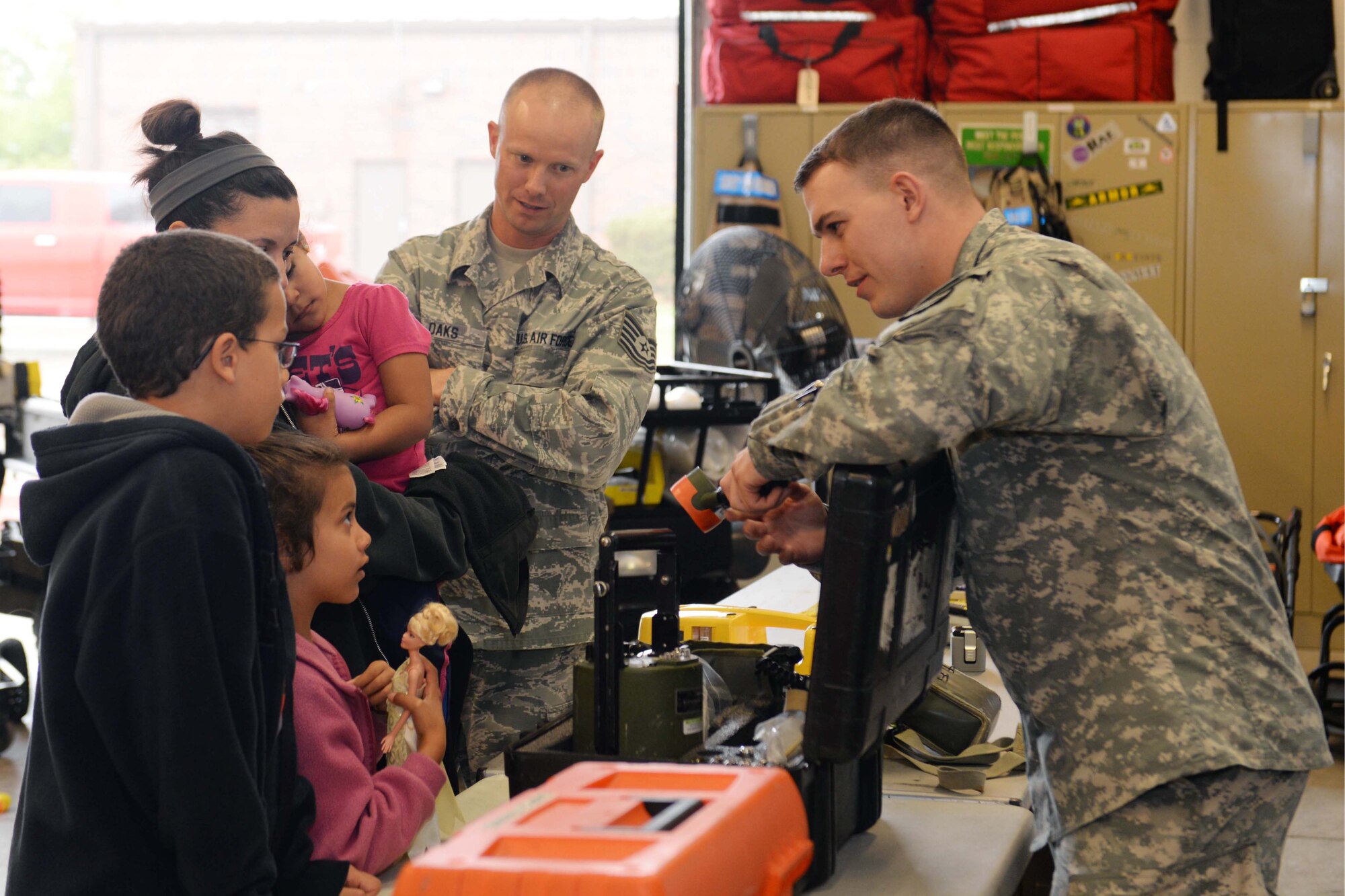 South Dakota National Guard Sgt. Michael Borbely, 82nd Civil Support Team survey team member, speaks with visitors at the open house about his job at Ellsworth Air Force Base, S.D., May 15, 2015. The open house celebrated the achievements of the 82nd CST, and provided servicemembers and their families a chance to learn about their mission and the men and women who make it possible. (U.S Air Force photo by Airman 1st Class Rebecca Imwalle / Released)