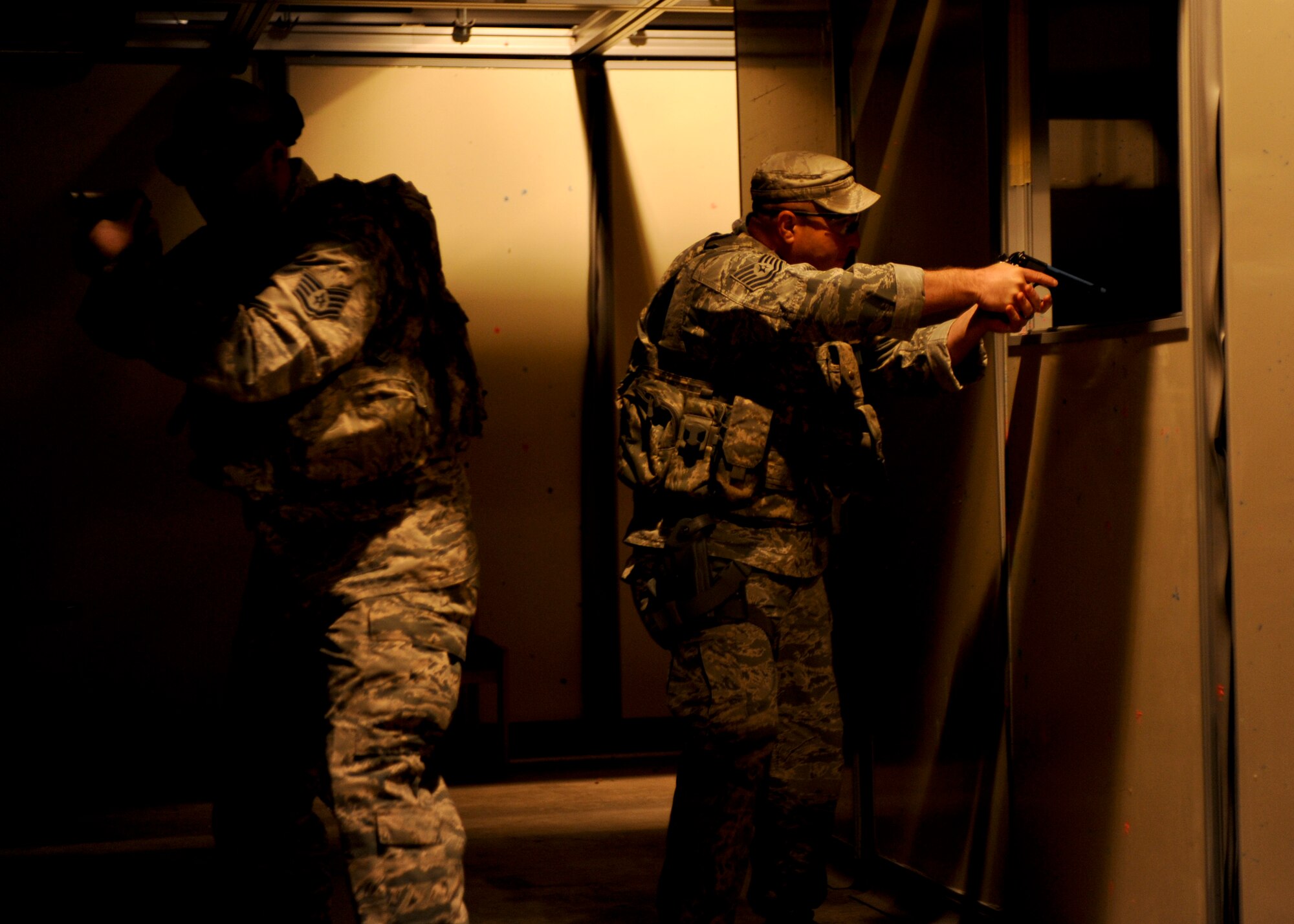Tech. Sgts. James Bolling and Branden Gandre, 28th Security Forces Squadron defenders, participate in a shoot-house competition as part of Police Week at Ellsworth Air Force, S.D., May 12, 2015. The competition was one of a variety of events held as part of Police Week, a time designated to recognize military and civilian police professionals for their contributions to the community. (U.S. Air Force photo by Senior Airman Anania Tekurio/Released)