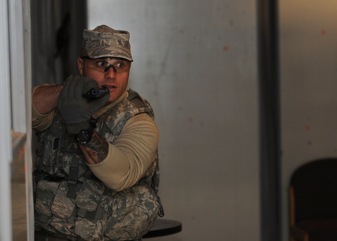 Master Sgt. Thomas Carpino, 28th Security Forces Squadron operations section chief, sweeps a room during a shoot-house competition as part of Police Week at Ellsworth Air Force Base, S.D., May 12, 2015. Police Week is an annual celebration and time to honor law enforcement officials and agencies throughout the nation. (U.S. Air Force photo by Senior Airman Anania Tekurio/Released)