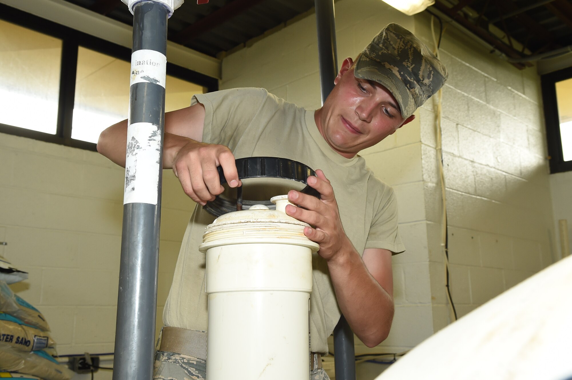 Airman 1st Class Caleb Bounty, 11th Civil Engineer Squadron water fuel system maintenance apprentice, completes an operational check of the base pool return line for potential chlorine leaks at Joint Base Andrews, Md., May 19, 2015. CES Airmen prepare the base pool for its slated opening of May 23. (U.S. Air Force photo/Senior Airman Joshua R. M. Dewberry) 