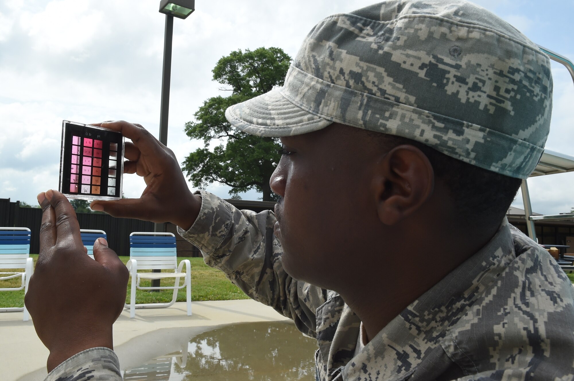 Senior Airman Jonathan Joshua, 11th Civil Engineer Squadron water fuel system maintenance craftsman, checks the pH balance of the base pool at Joint Base Andrews, Md., May 19, 2015. CES Airmen prepare the base pool for its slated opening of May 23. (U.S. Air Force photo/Senior Airman Joshua R. M. Dewberry) 