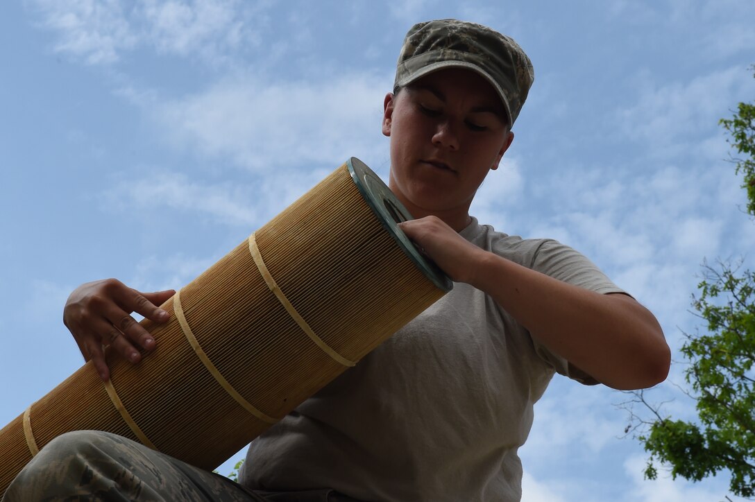 Airman 1st Class Makenzie Letterman, 11th Civil Engineer Squadron water fuel system maintenance journeyman, replaces filters for the base pool sanitary pit at Joint Base Andrews, Md., on May 19, 2015. CES Airmen prepare the base pool for its slated opening of May 23. (U.S. Air Force photo/Senior Airman Joshua R. M. Dewberry) 