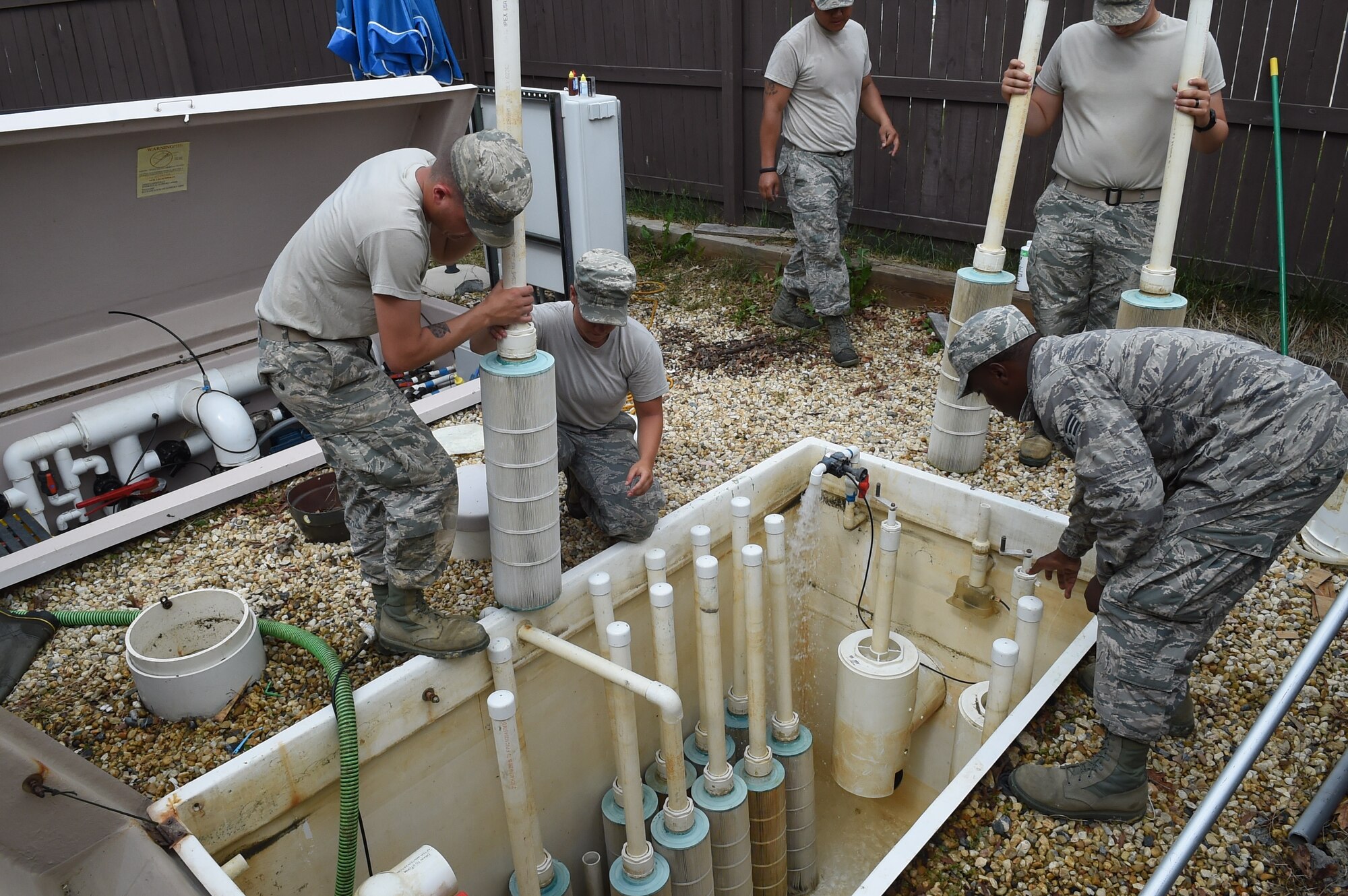 The 11th Civil Engineer Squadron water fuel system maintenance Airmen test and replace filters for the base pool sanitary pit at Joint Base Andrews, Md., May 19, 2015. CES Airmen clean in preparation for the base pool’s slated opening of May 23. (U.S. Air Force photo/Senior Airman Joshua R. M. Dewberry) 