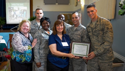 Airmen from the Joint Base Charleston chapter of the Keeping North Charleston Beautiful program were awarded the Captain Pride Award at the Felix C. Davis Community Center, North Charleston, S.C., May 15, 2015. Their work on the Community Butterfly Garden was recognized by the Charleston County Community Pride Organization. (Pictured left to right; Hon. Colleen Condon - Charleston City Council member, Senior Airman Zachary Woodard - 628th CPTS, Airman Shabria Brownlee – 628th CS, Vonie Gilreath – Pride Chairman, Master Sergeant Anthonio Dais – 437th MXS, Technical Sergeant Erica Dais – 628 CES, and Senior Airman Charles Stevens – 437th APS.) (U.S. Air Force Photo / Senior Airman Michael Reeves)