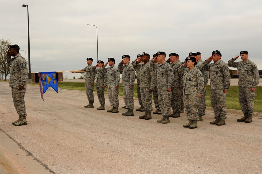 Members of the 28th Security Forces Squadron salute the flag during a National Police Week retreat ceremony at Ellsworth Air Force Base, S.D., May 14, 2015. Ellsworth paid tribute to approximately 63 fallen security forces personnel Air Force-wide and police officers from the state of South Dakota during the ceremony. (U.S. Air Force photo by Senior Airman Hailey R. Staker/Released)