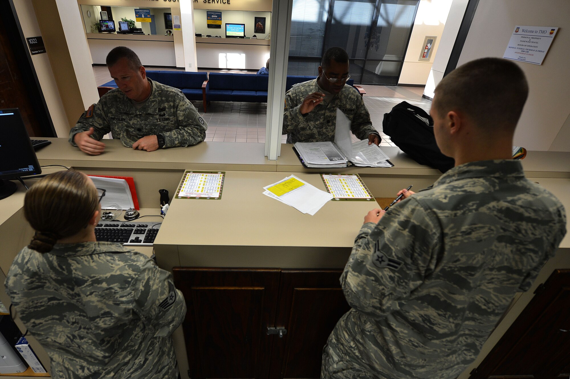 U.S. Air Force Airmen assigned to the 20th Logistics Readiness Squadron traffic management office, assist Team Shaw members with in-processing and out-processing at Shaw Air Force Base, S.C., May 19, 2015. Summer is the peak of permanent change of station season in which the TMO office could service approximately 3,500 outgoing and incoming Team Shaw members. (U.S. Air Force photo by Airman 1st Class Michael Cossaboom/Released)