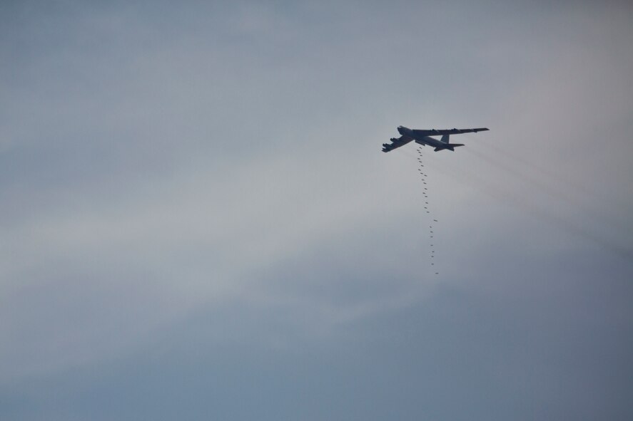 A U.S. Air Force B-52H Stratofortress drops Guided Bomb Unit-38's during a combined live fire demonstration during Exercise Eager Lion in Wadi Shadiya, Jordan, May 18, 2015. Eager Lion is a recurring, multinational exercise designed to strengthen military-to-military relationships, increase interoperability between partner nations, and enhance regional security and stability. (U.S. Marine Corps photo by Cpl. Sean Searfus CE MARFOR CENTCOM FWD COMCAM/ Released)