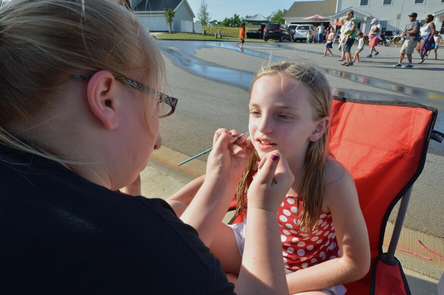 A Team Shaw member gets her face painted during a base-wide block party at Shaw Air Force Base, S.C., May 17, 2015. Throughout the evening Team Shaw members were provided free food, music, and in various comradery building activities. (U.S. Air Force photo by Airman 1st Class Michael Cossaboom/Released)