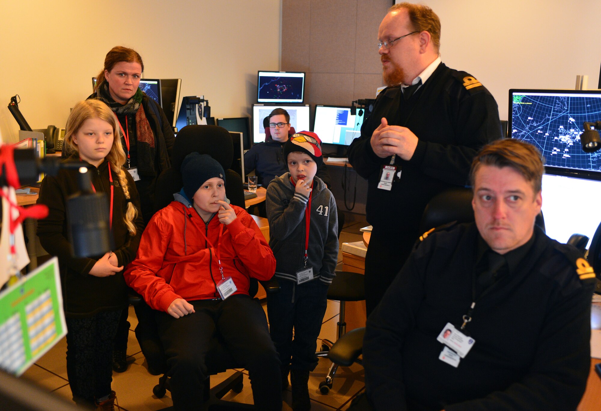 Gunnar Guðlaugsson, Arna Tryggvadóttir and their families listen to briefings by Icelandic Coast Guard and U.S. Air Force personnel at the Control and Reporting Center during the 871st Air Expeditionary Squadron Pilot for a Day program at Keflavik International Airport, Iceland, May 13, 2015. As part of the program, both children toured the CRC and participated in a simulated mission. (U.S. Air Force photo by 2nd Lt. Meredith Mulvihill/Released)