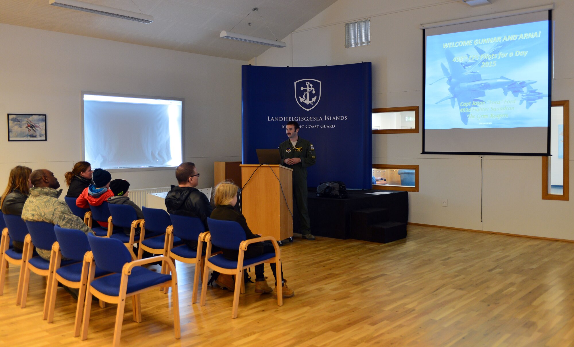 U.S. Air Force Capt. Jason Ford, an F-15C Eagle fighter aircraft pilot from the 871st Air Expeditionary Squadron, briefs the families of Gunnar Guðlaugsson and Arna Tryggvadóttir during the Pilot for a Day program at Keflavik International Airport, Iceland, May 13, 2015. The program allowed two terminally ill Icelandic children to tour operations at Keflavik and experience a day in the life of a U.S. Air Force pilot.(U.S. Air Force photo by 2nd Lt. Meredith Mulvihill/Released)