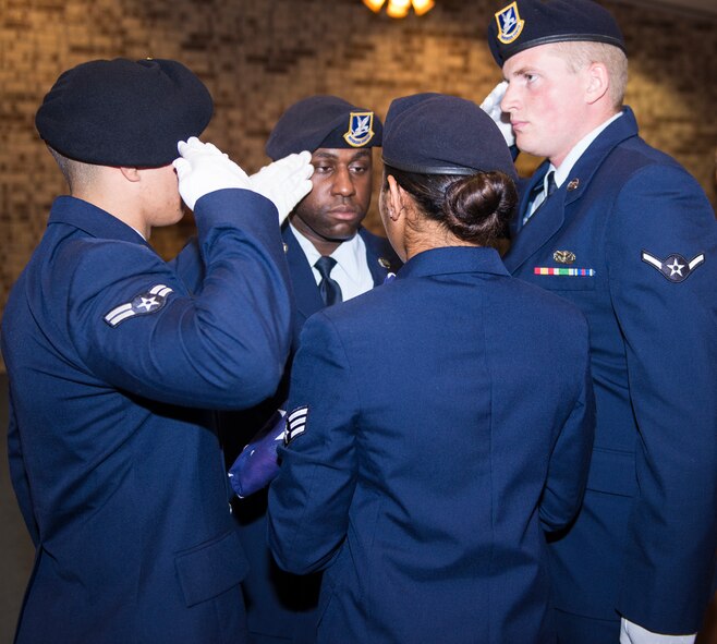 Members of the 23d Security Forces Squadron salute the American Flag during the playing of Taps at the 2015 National Police Week Memorial Ceremony May 15, 2015, at Moody Air Force Base, Ga. Since 1862, the playing of taps has been used to honor fallen service members for their ultimate sacrifice. (U.S. Air Force photo by Airman Greg Nash/Released)