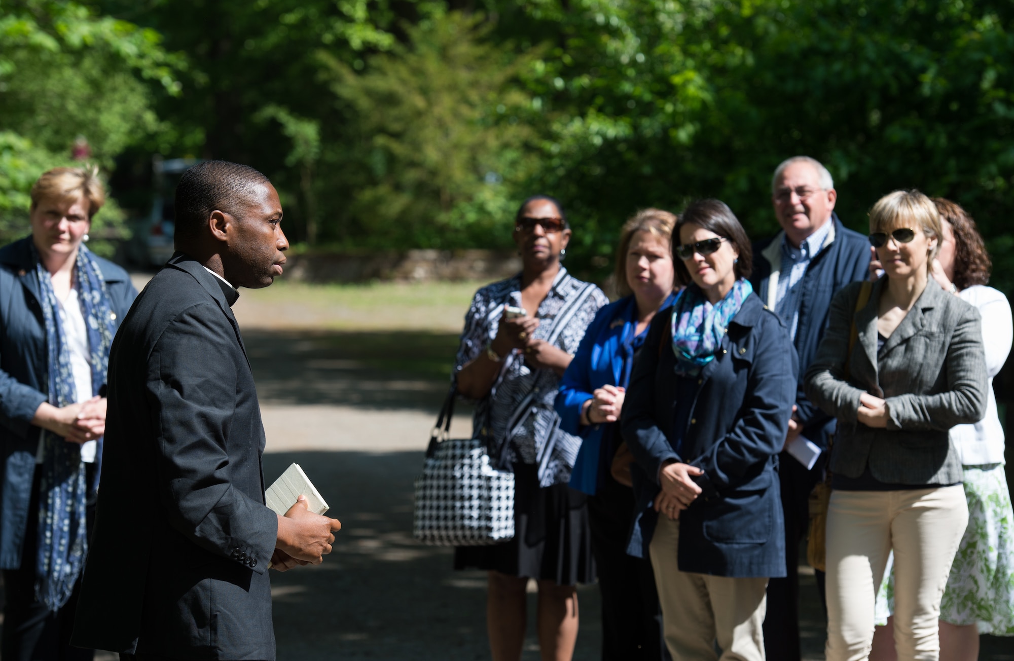U.S. Air Force Capt. Cyriacus Onyejegbu, 86th Airlift Wing chaplain, speaks with the audience during the Kindergraves memorial service May 16, 2015, in Kaiserslautern, Germany. Children buried here were no more than 12 months old during 1952 to 1971, most died of various childhood diseases or birth complications. Representatives from Ramstein Air Base, Germany, and the host nation serve as co-chairs for the Kaiserslautern Kindergraves Memorial Foundation which maintains open communication with families, preserves historical archives, conducts ceremonies and provides oversight to site maintenance. (U.S. Air Force photo/Senior Airman Jonathan Stefanko)