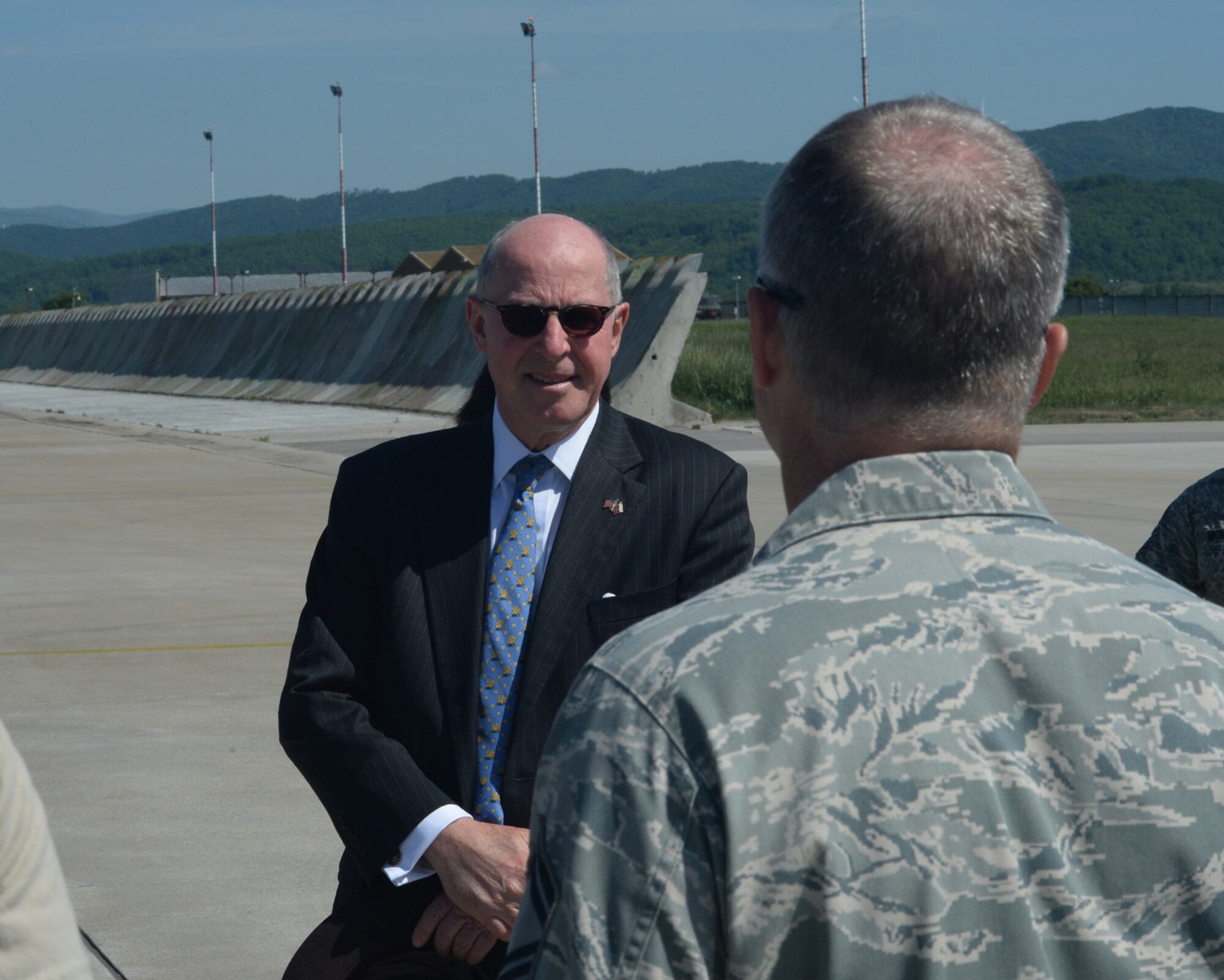 Theodore Sedgwick, U.S. Ambassador to Slovakia, speaks to a U.S. Air Force Airman assigned to the 354th Expeditionary Fighter Squadron during a theater security package deployment at Sliac Air Base, Slovakia, May 18, 2015. The U.S. values the shared commitment and close cooperation with NATO partners on the security and stability of Europe. (U.S. Air Force photo by Senior Airman Dylan Nuckolls/Released)