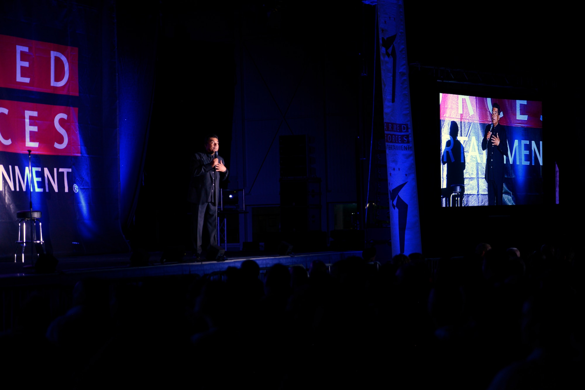 Comedian, actor and talk show host George Lopez entertains a crowd by performing his comedy routine for an Armed Forces Entertainment event at on Ramstein Air Base, Germany, May 16, 2015. The free show was held to provide entertainment to military families. (U.S. Air Force photo/Staff Sgt. Kris Levasseur)
