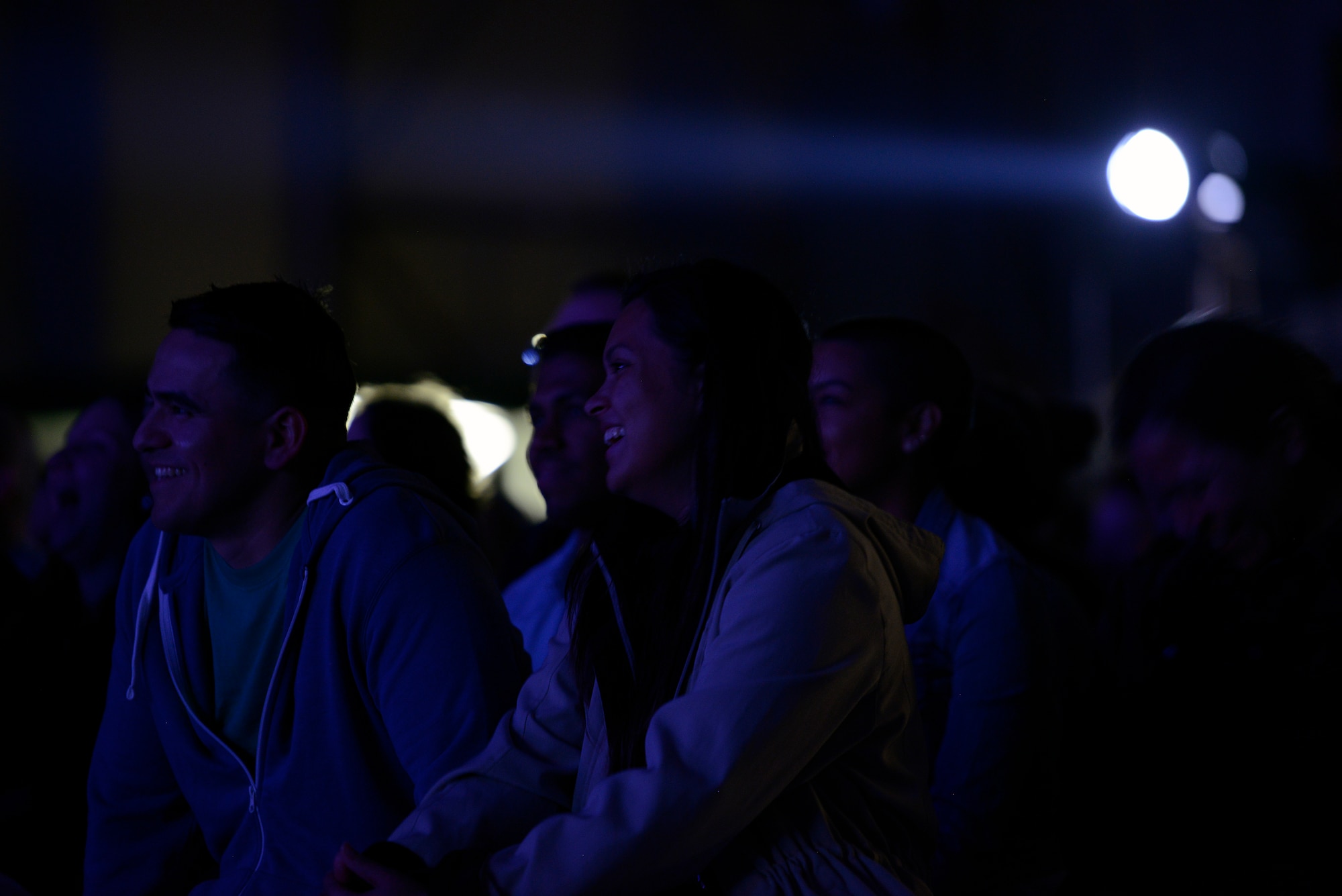 Airmen and their family members watch as George Lopez, a comedian, actor and talk show host, entertains a crowd by performing his comedy routine for an Armed Forces Entertainment event in a hangar on Ramstein Air Base, Germany, May 16, 2015. The event was conducted to show appreciation for what military members and their families contribute on a daily basis. (U.S. Air Force photo/Staff Sgt. Kris Levasseur)