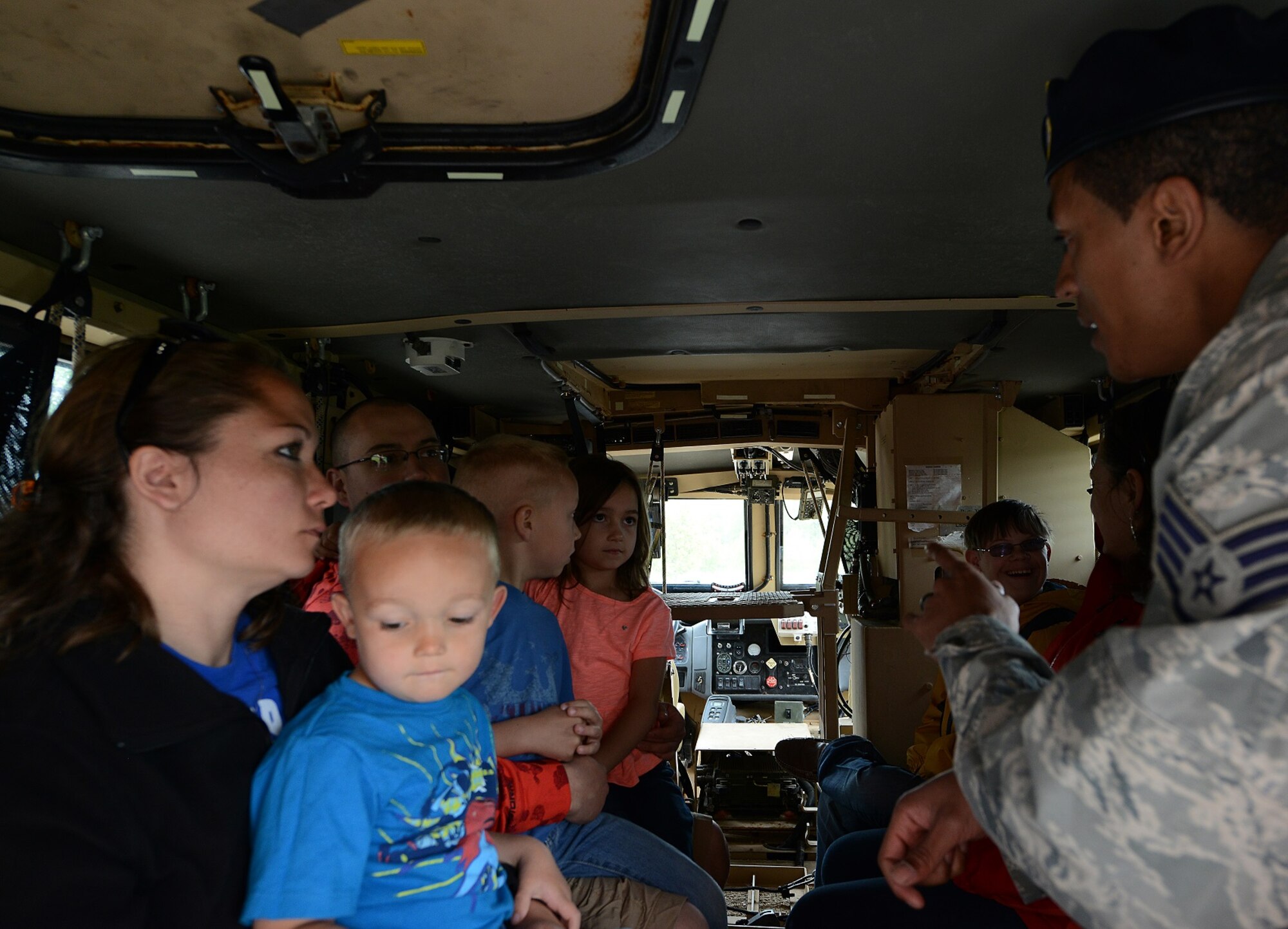 Staff Sgt. Ritchie Brown, 435th Security Forces Squadron instructor, educates members of the Kaiserslautern Military Community about the Max Pro mine-resistant ambush-protected vehicle during a display for National Police Week May 9, 2015, at Ramstein Air Base, Germany. Patrons were also able to enter police cars and play the sirens during the event. (U.S. Air Force photo/Airman 1st Class Tryphena Mayhugh)