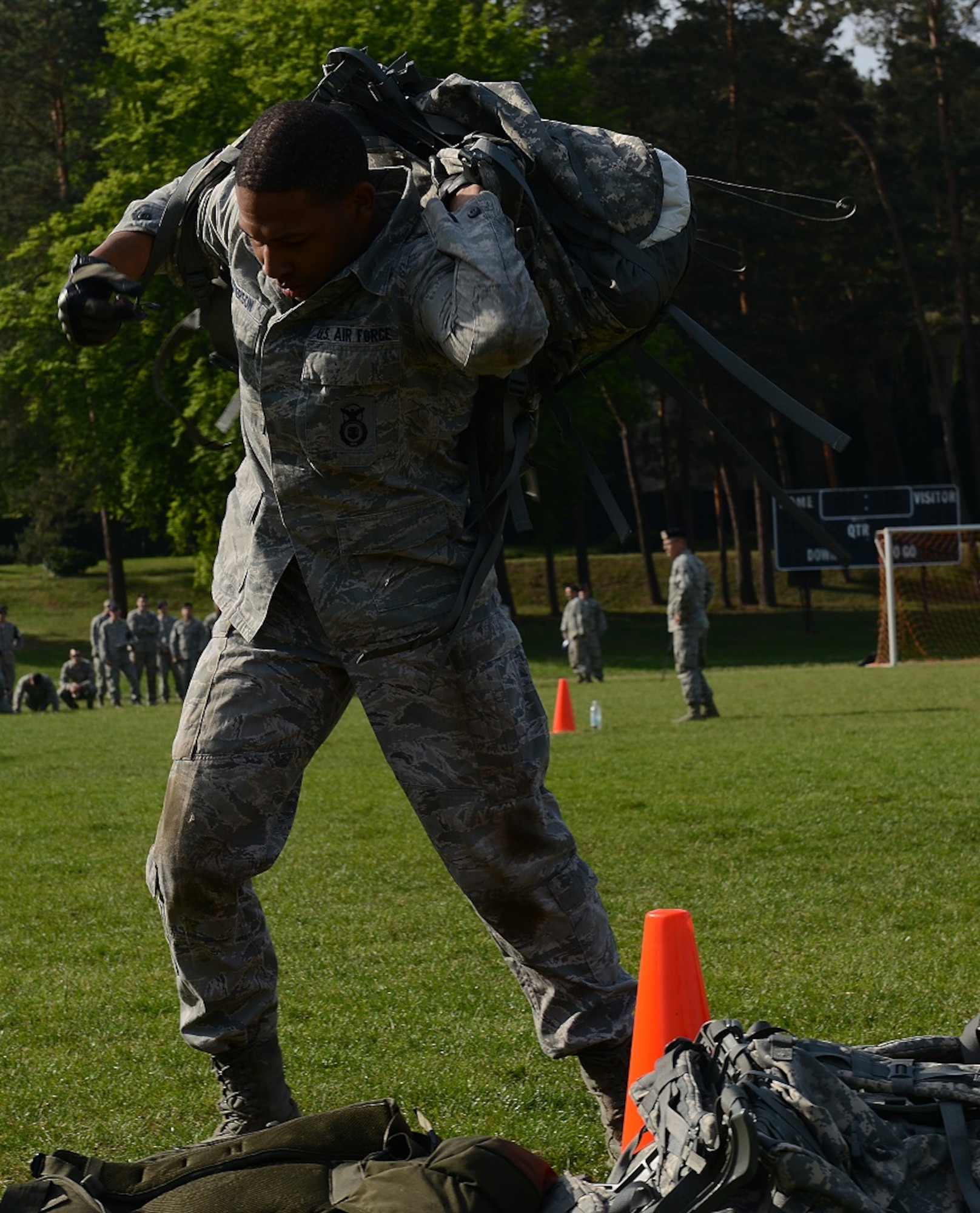 Senior Airman Stephen Peterson, 86th Security Forces Squadron patrolman, picks up a 50-pound rucksack as part of the Battle of the Badges competition held in honor of National Police Week May 14, 2015, at Vogelweh Military Complex, Germany. Other challenges in the course including high crawls, bear crawls, squats, push-ups and flutter kicks. (U.S. Air Force photo/Airman 1st Class Tryphena Mayhugh)